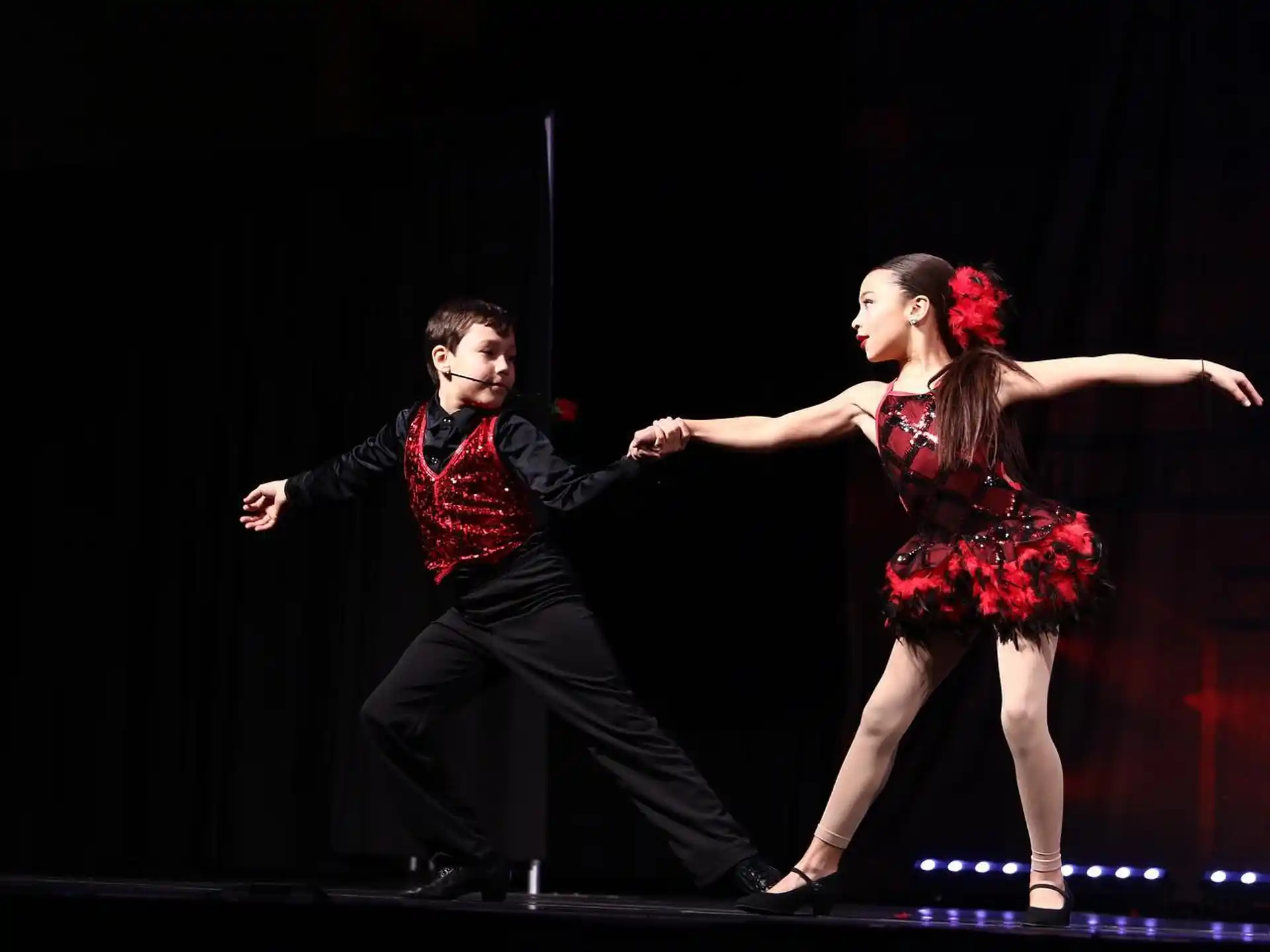 a man and woman dancing on a stage