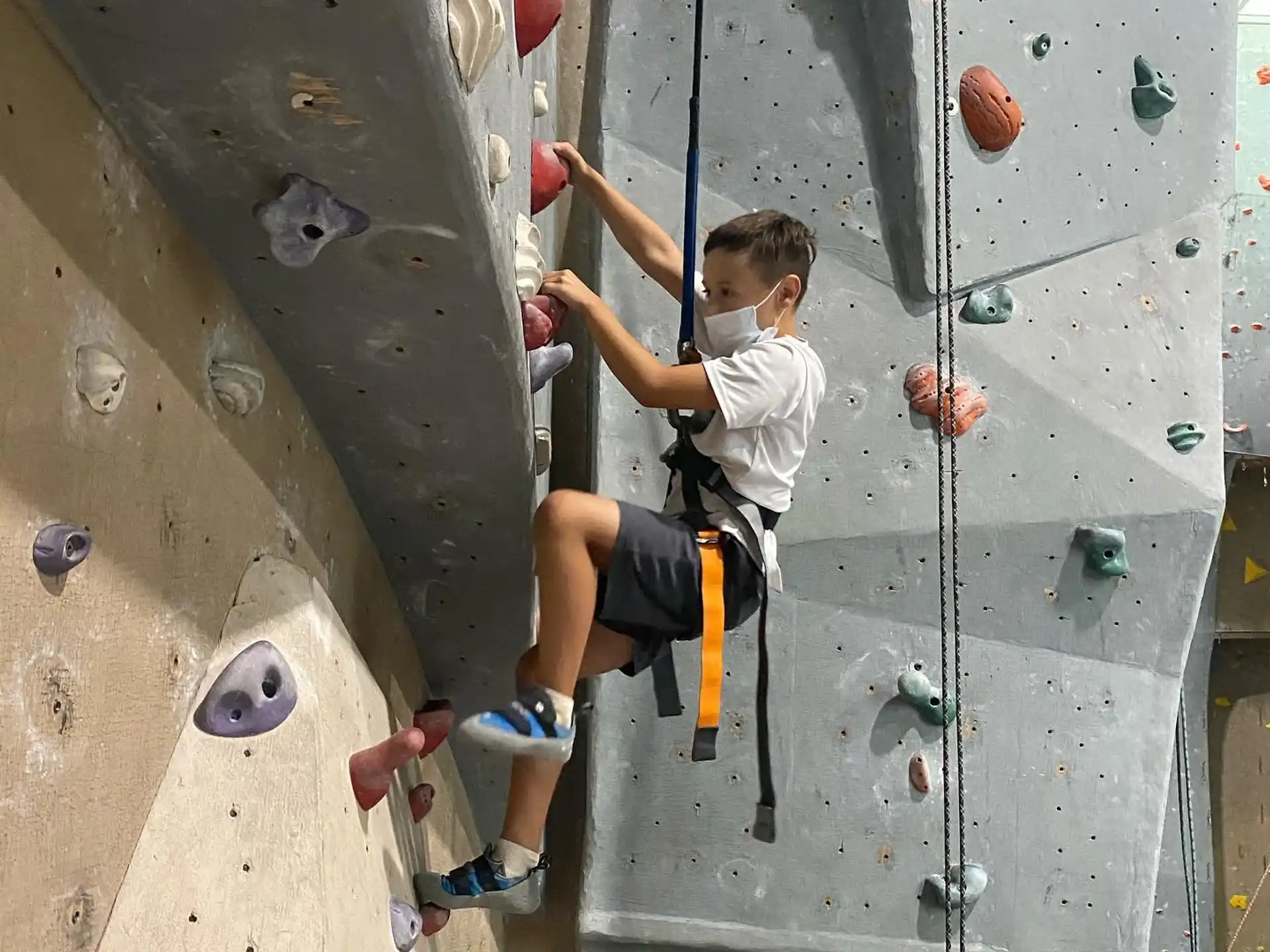 a boy climbing a rock wall