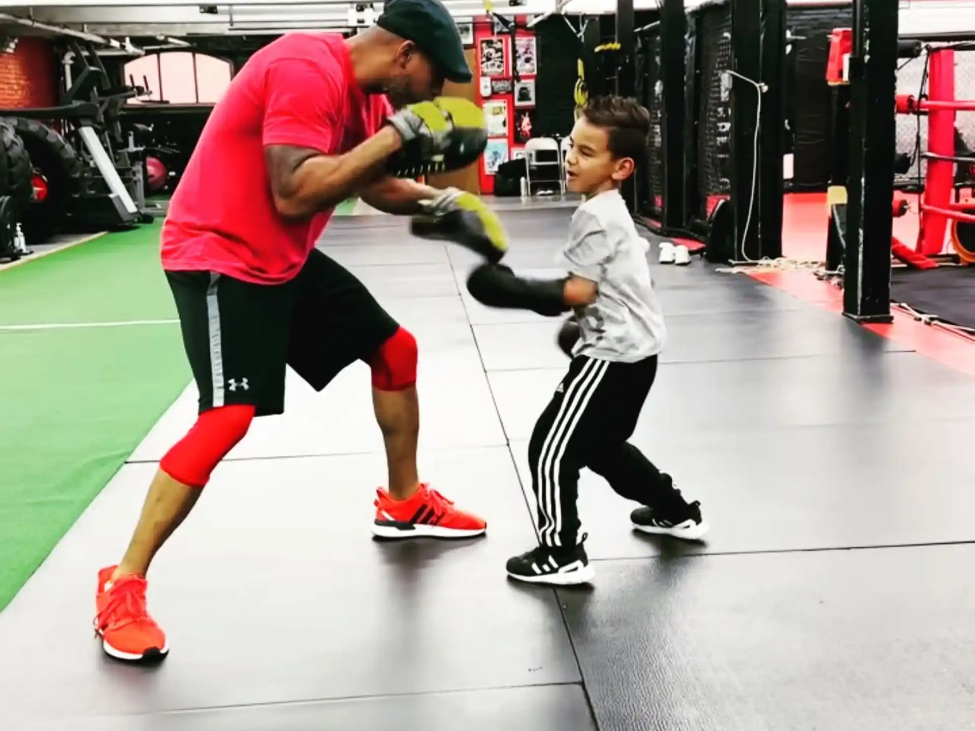a person and a boy in a gym