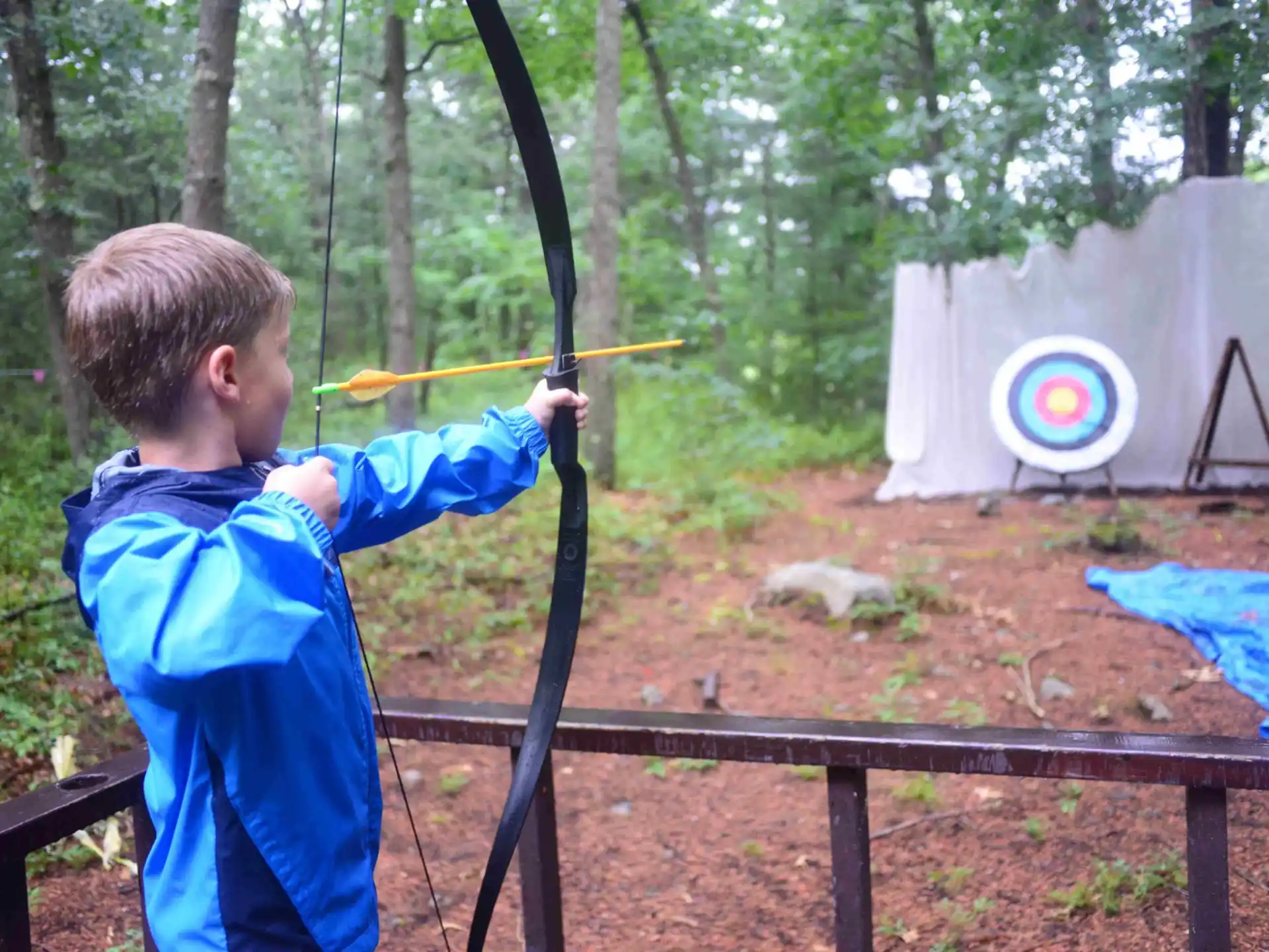 a boy shooting a bow and arrow