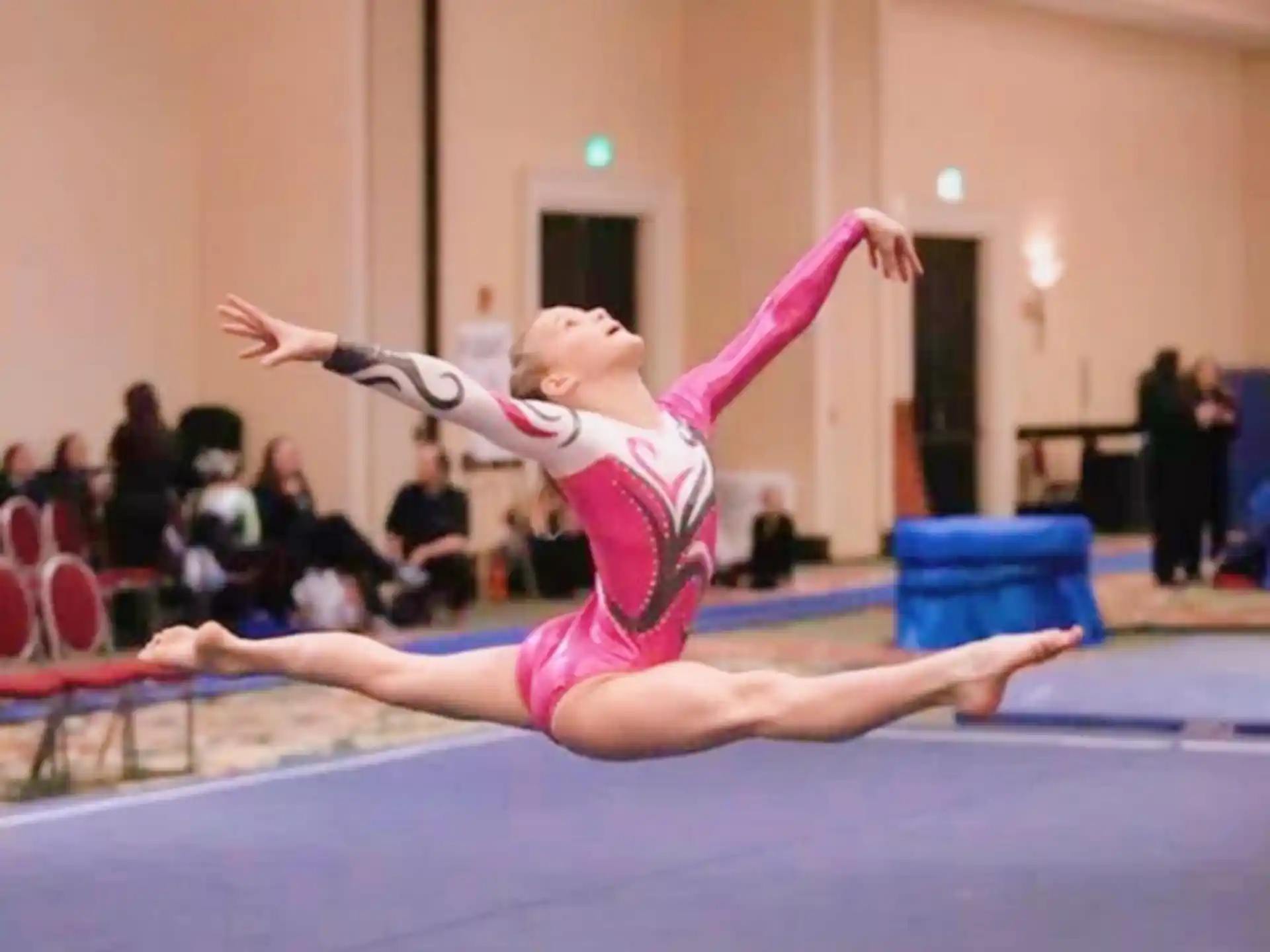 a woman doing a gymnastics move