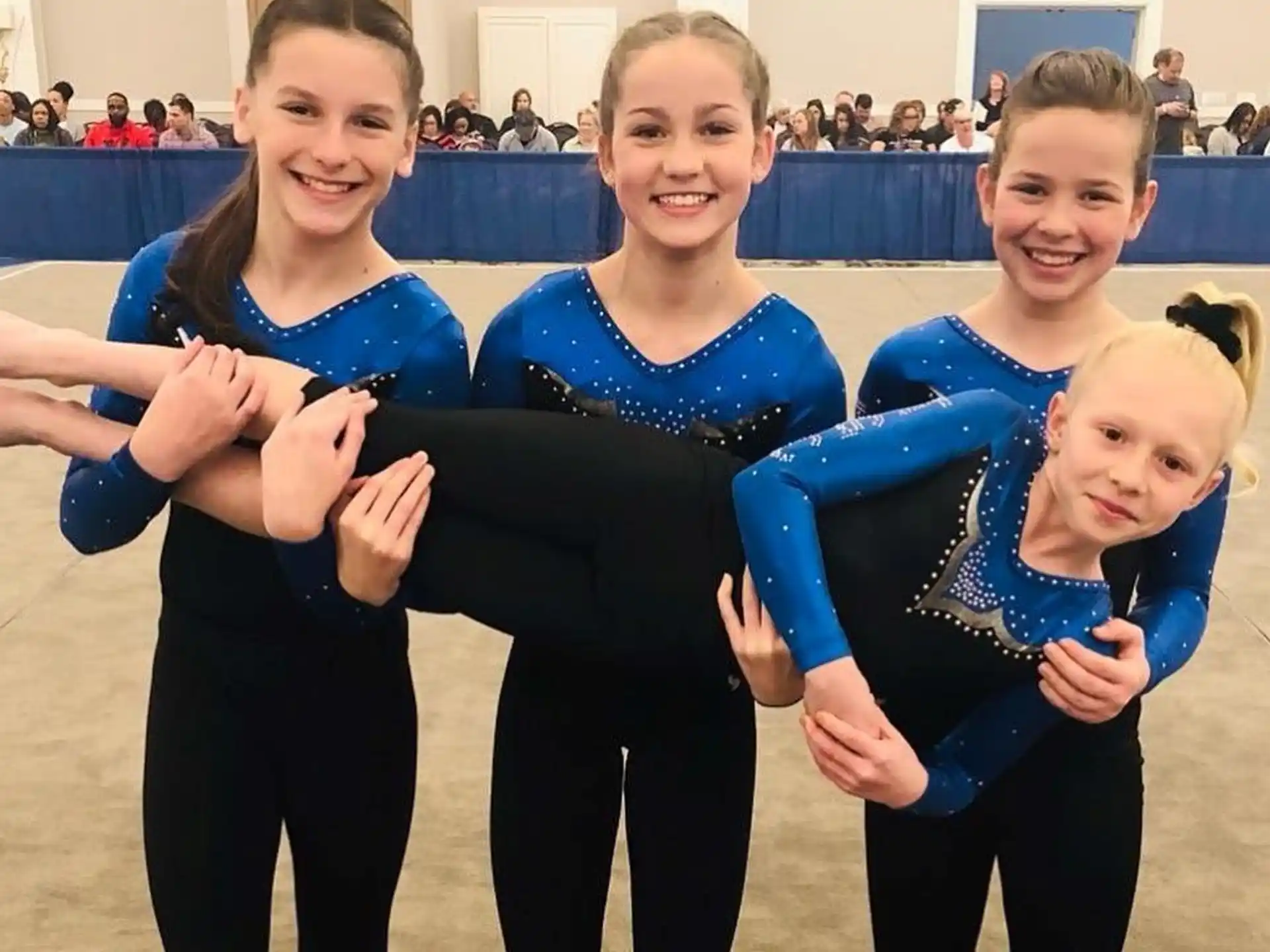 a group of women in leotards posing for a photo