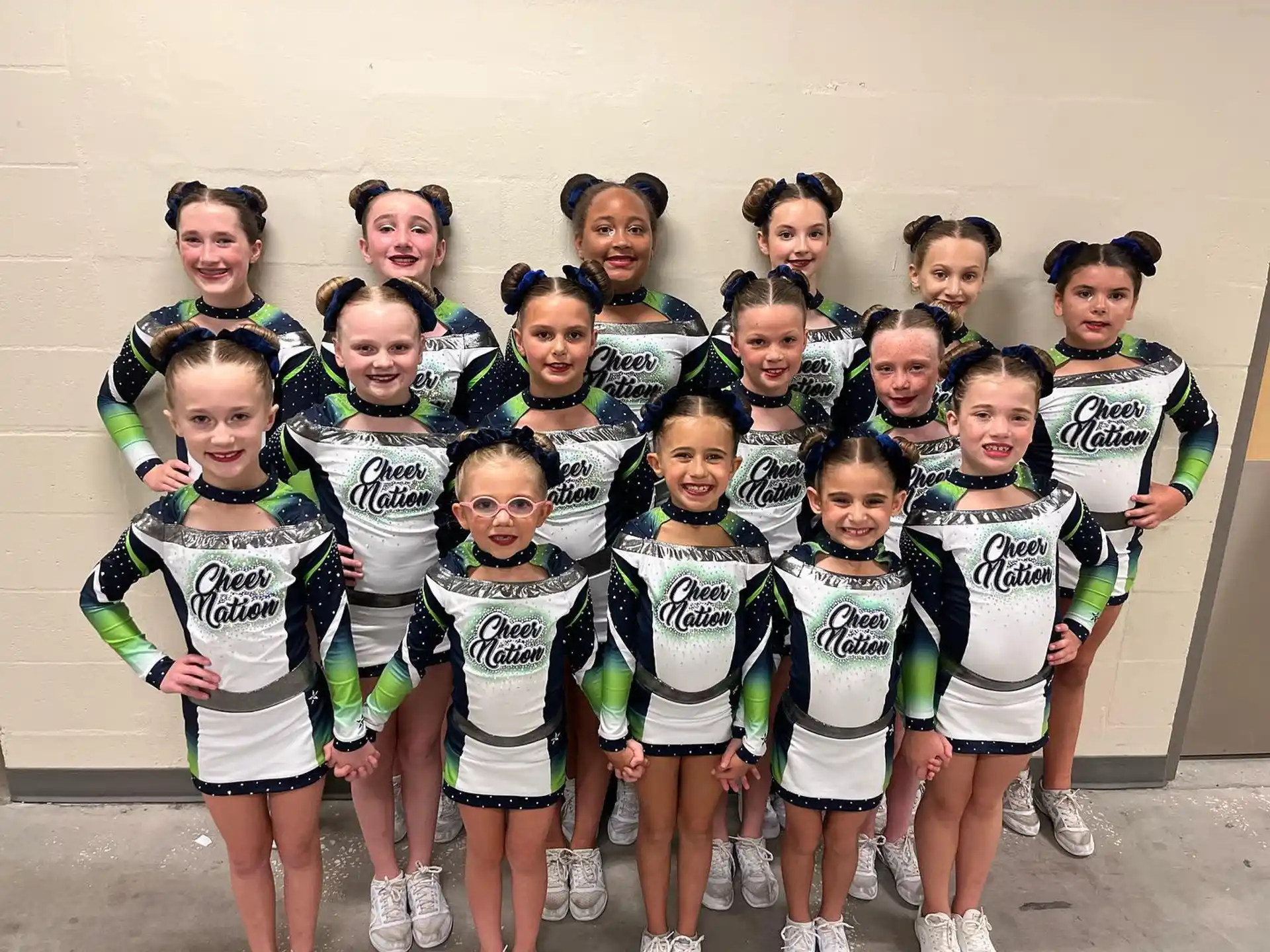 a group of girls in matching white and black uniforms