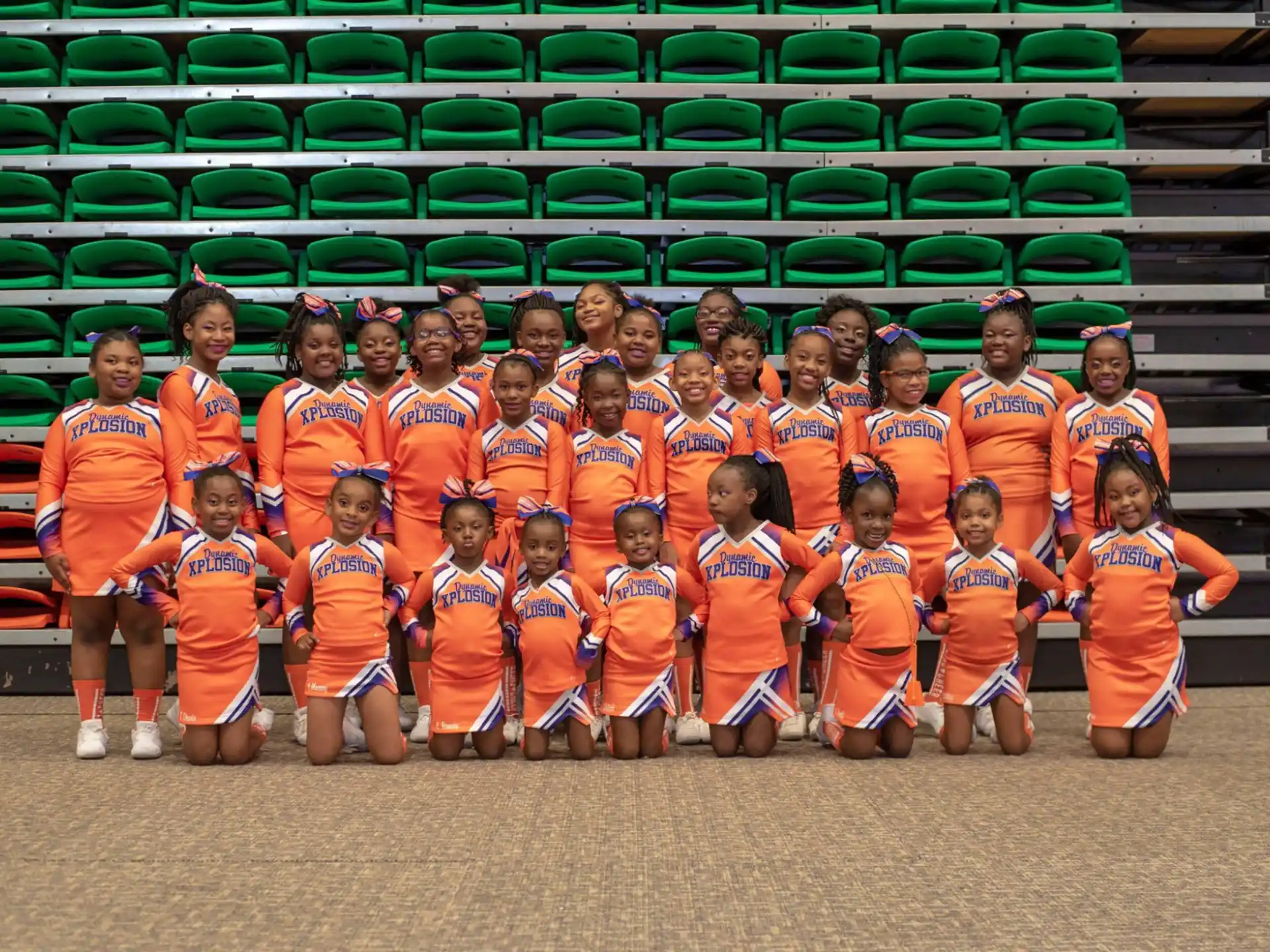 a group of kids in orange uniforms