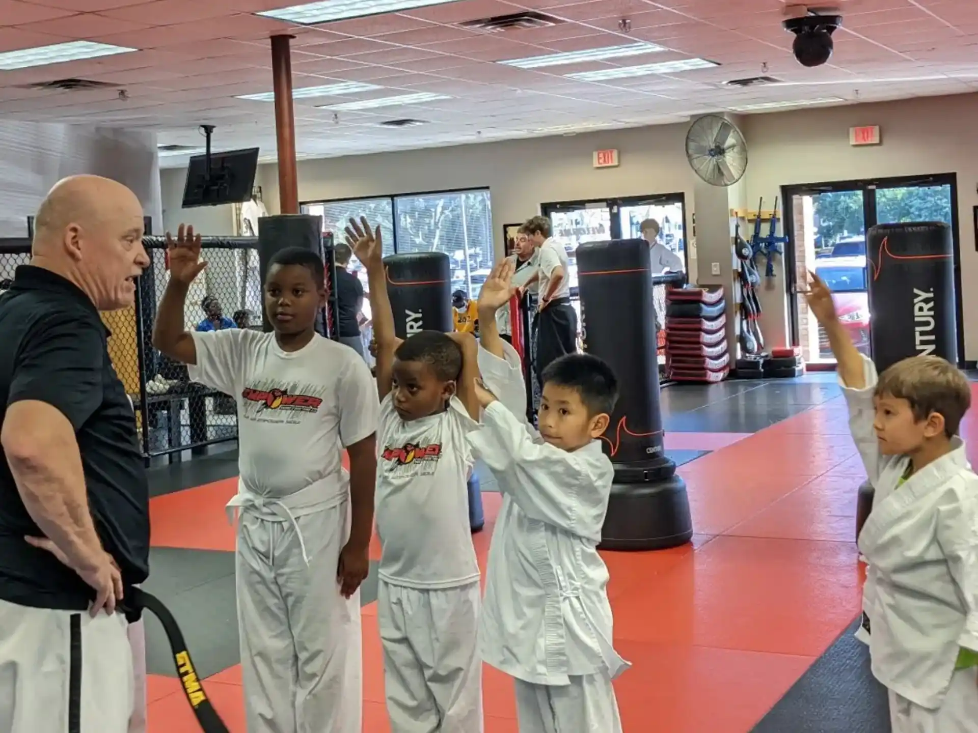a group of people in white karate uniforms