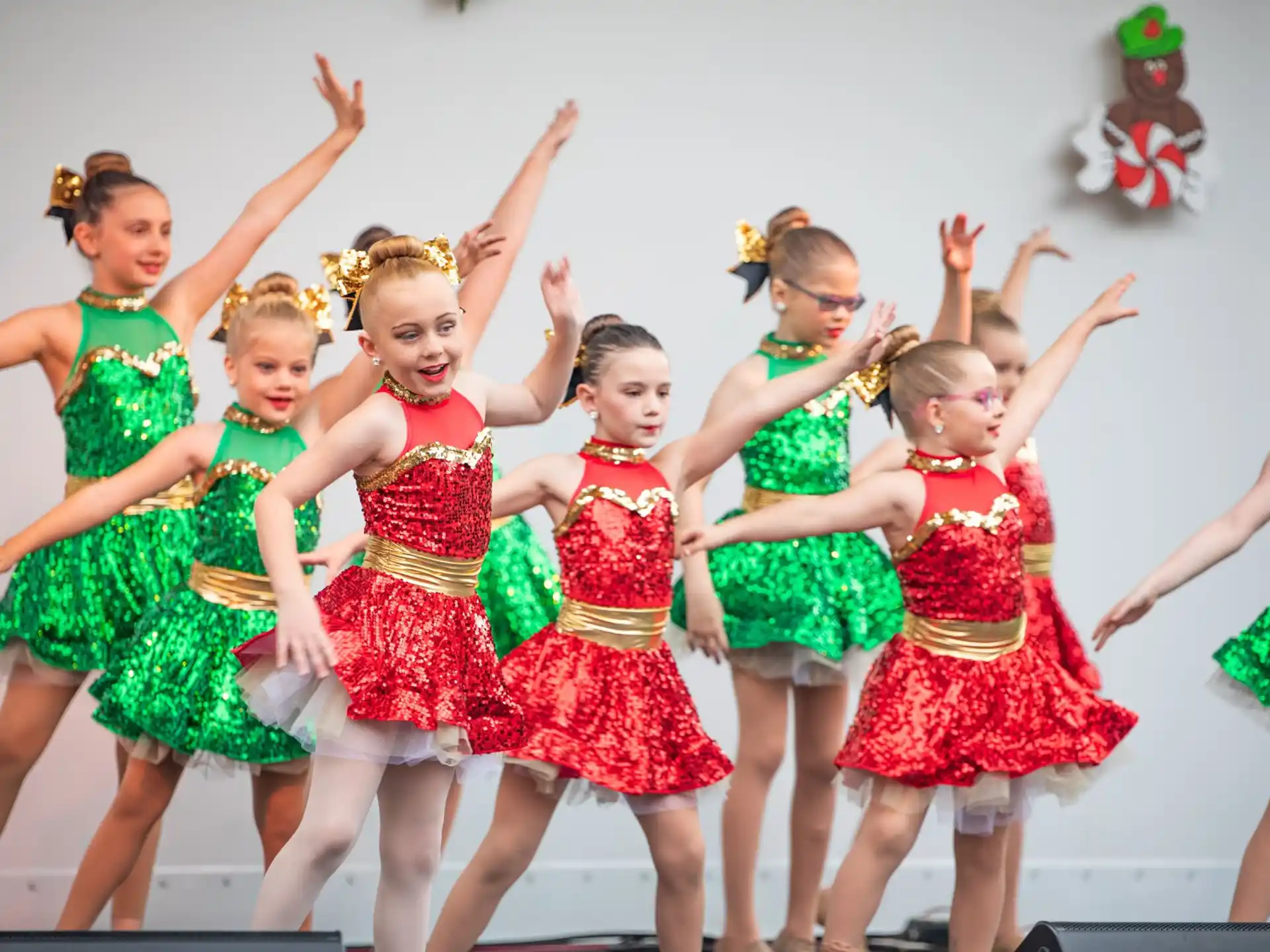 a group of girls in colorful dresses dancing