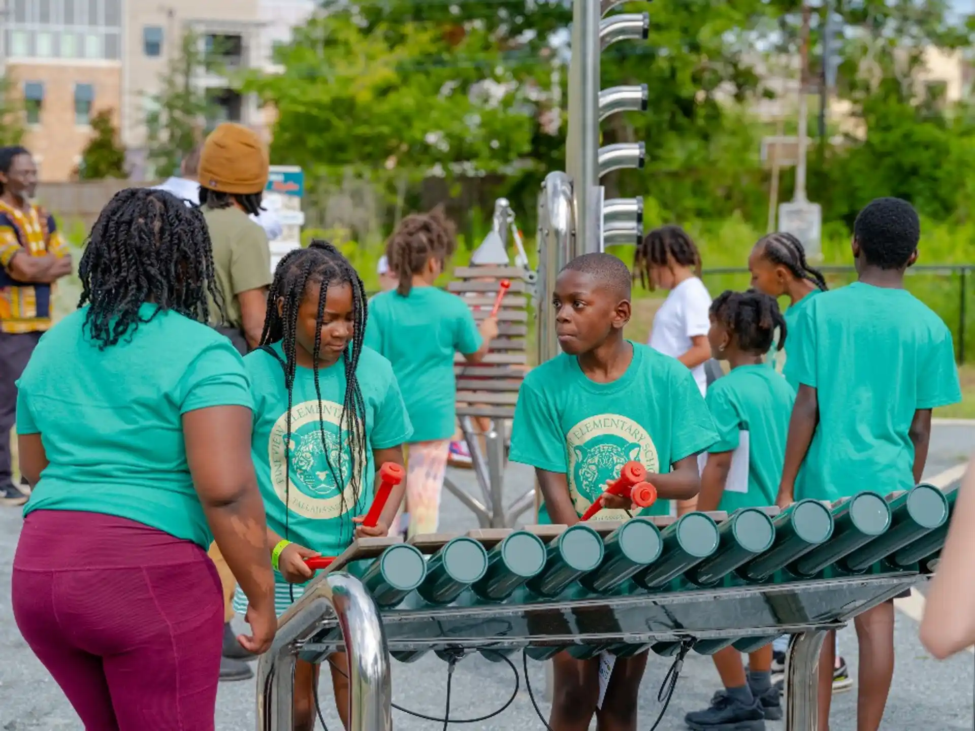 a group of people standing around a table with food on it