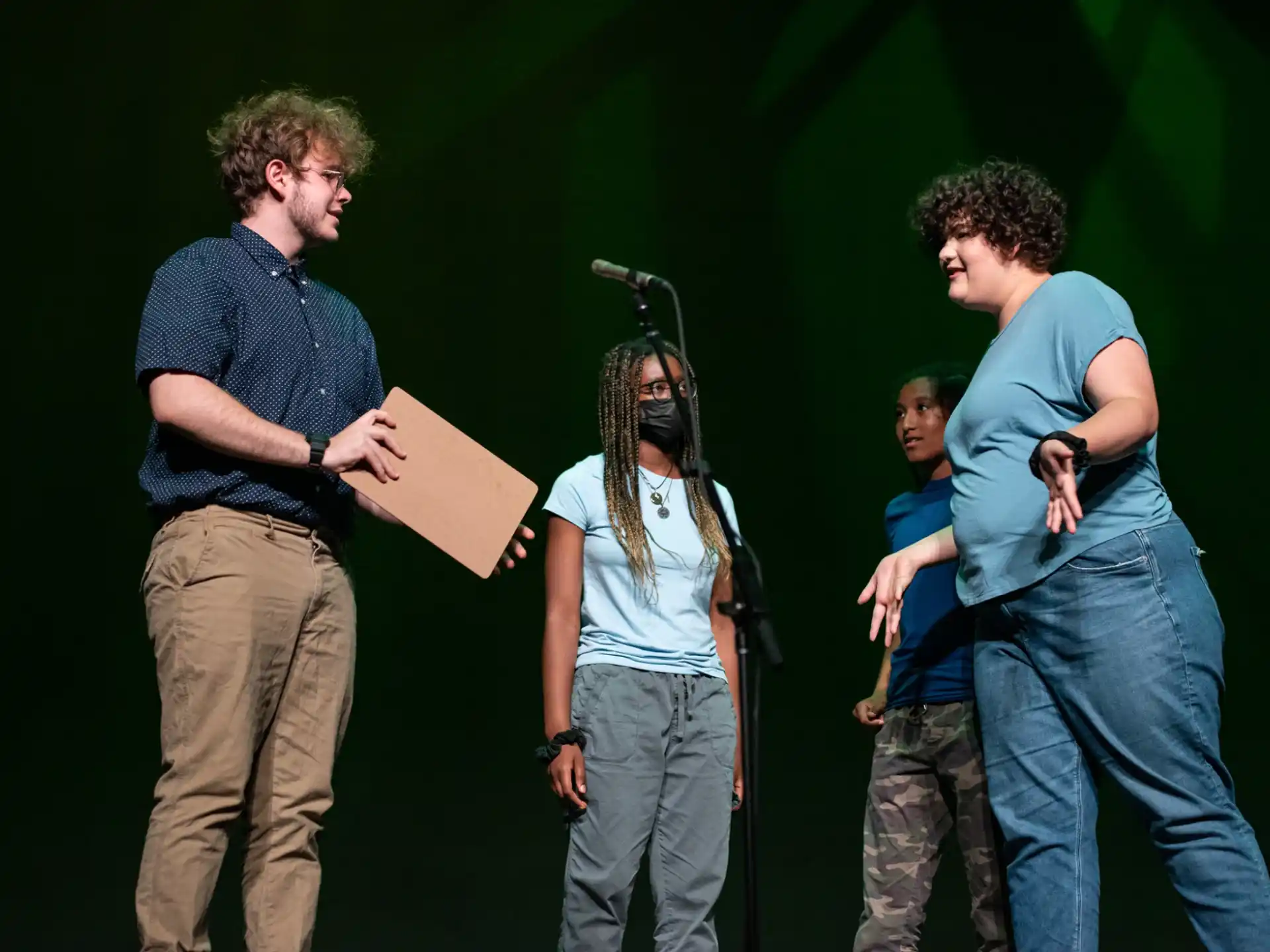 a group of people standing in front of a microphone