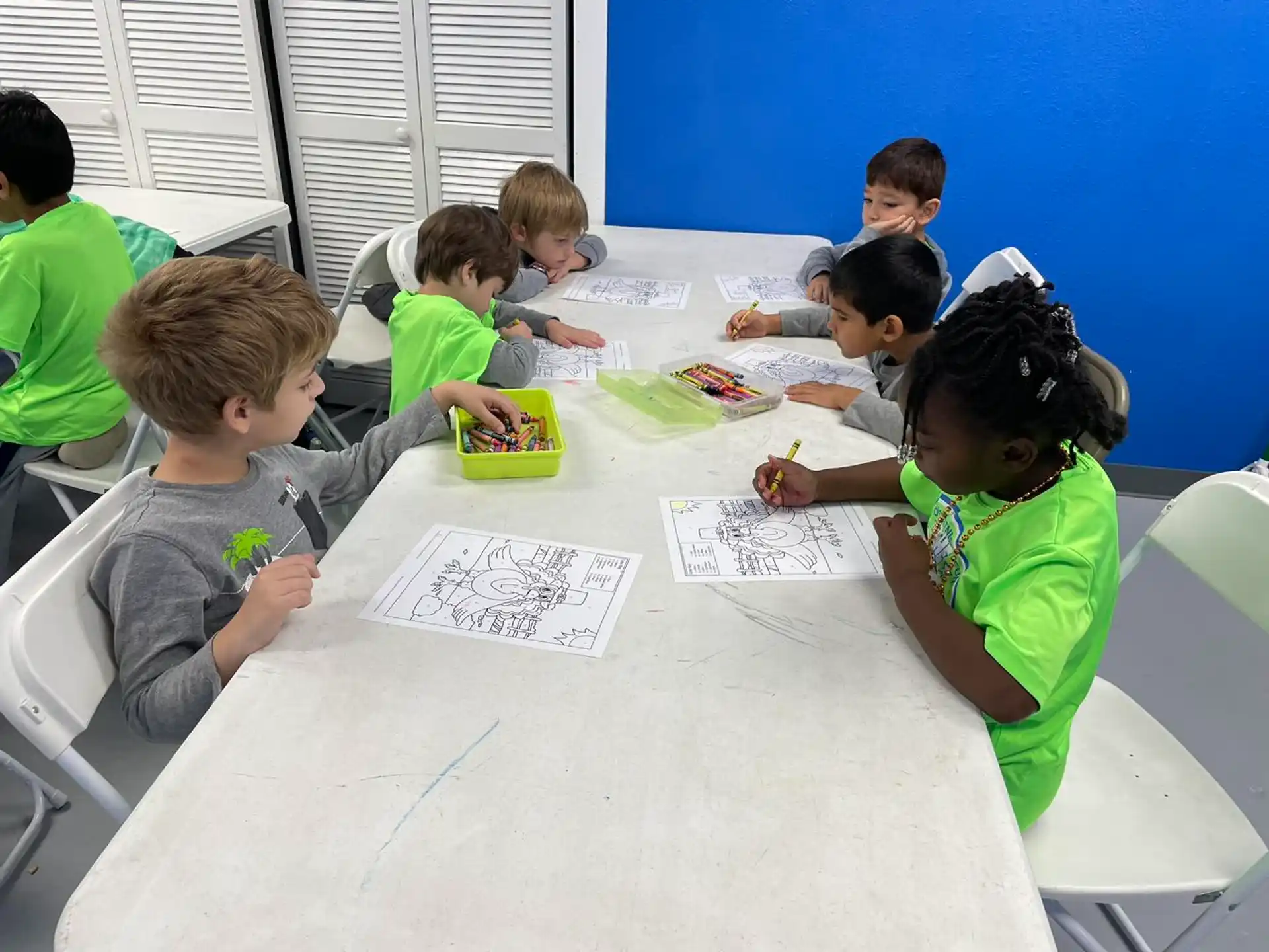a group of children sitting around a table