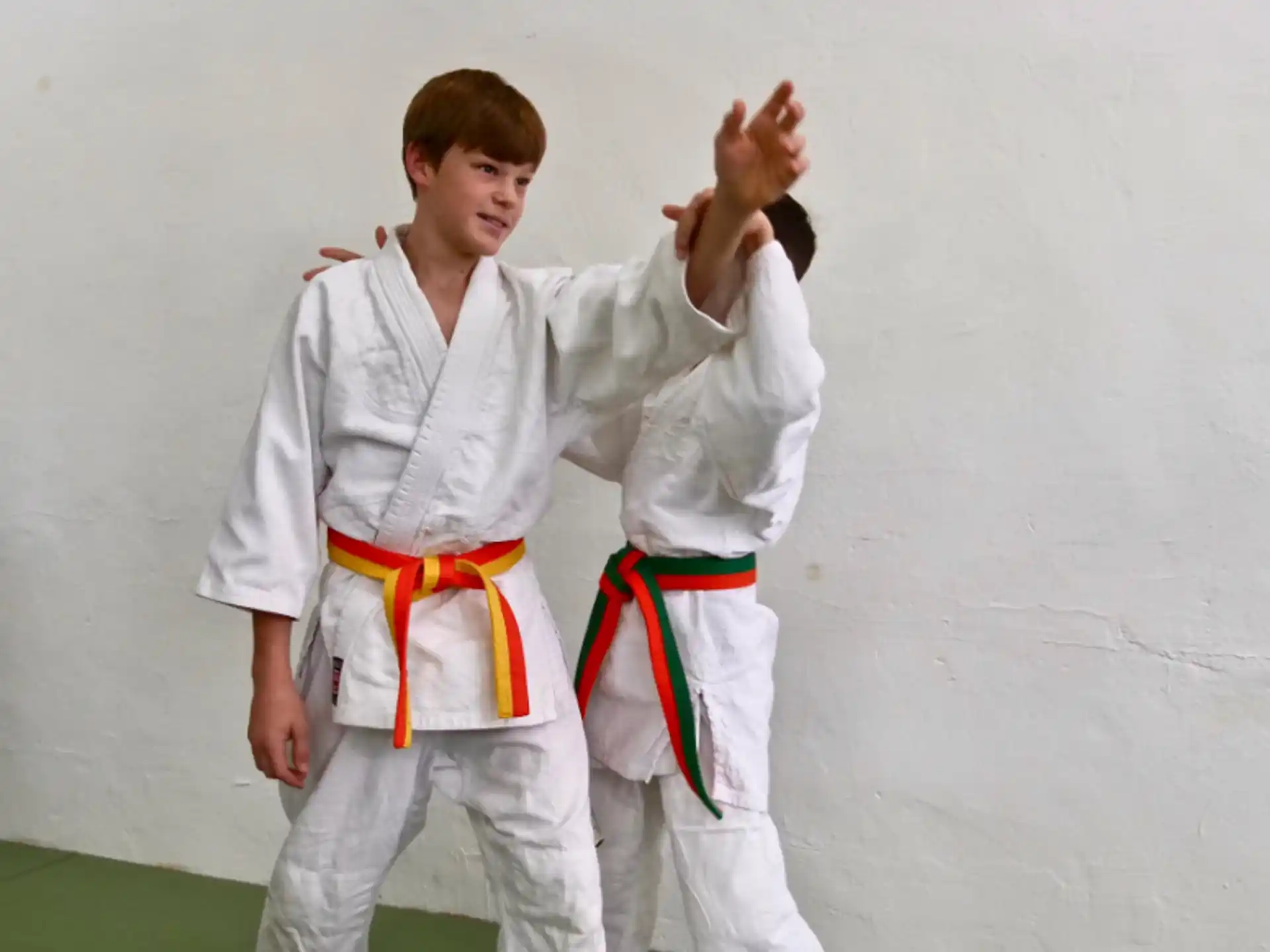 a man and woman in karate uniforms