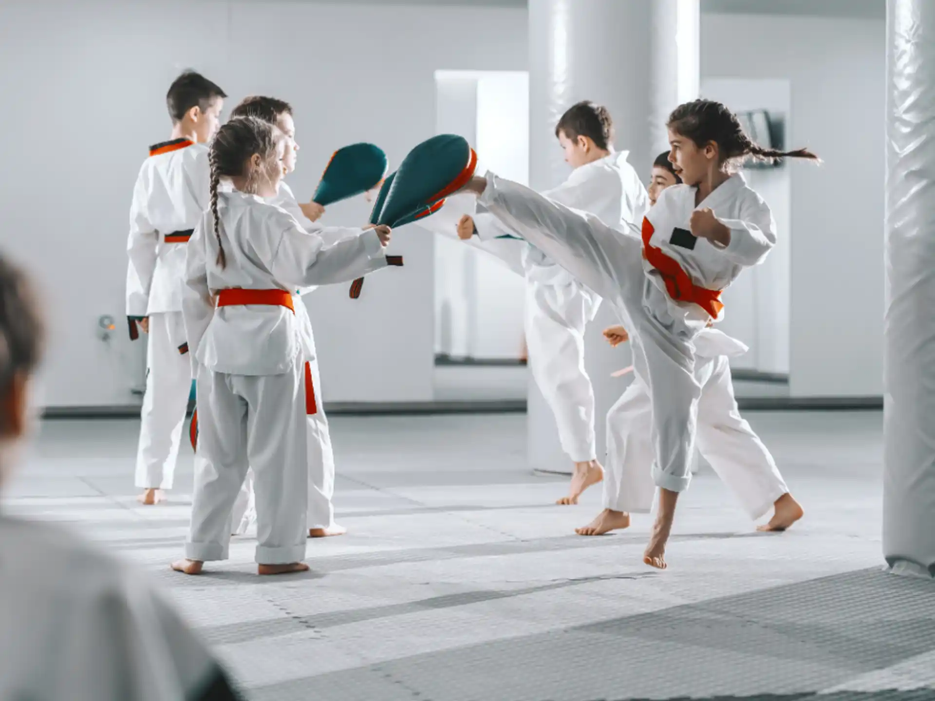 a group of people in white karate uniforms