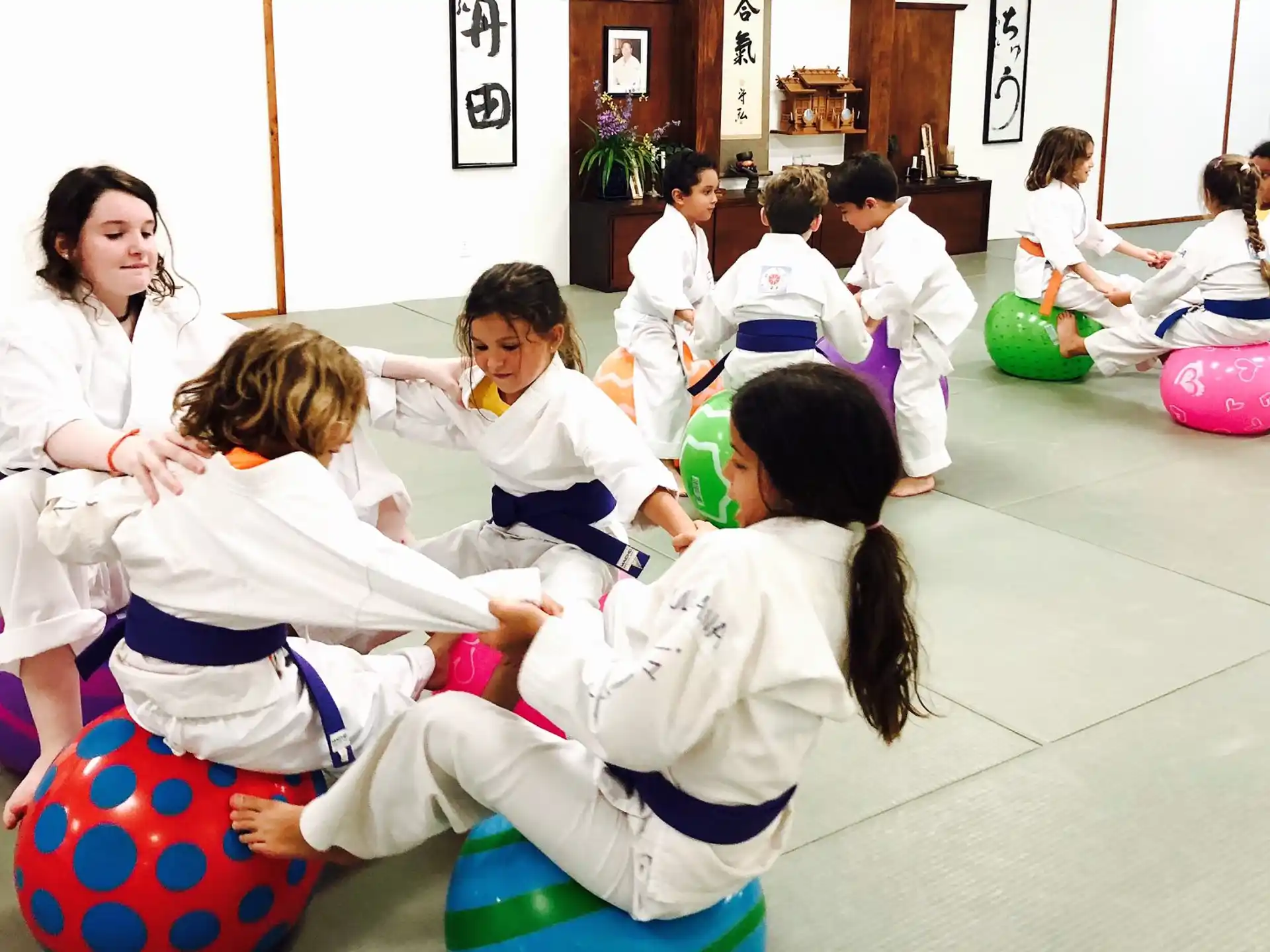 a group of children in white karate uniforms