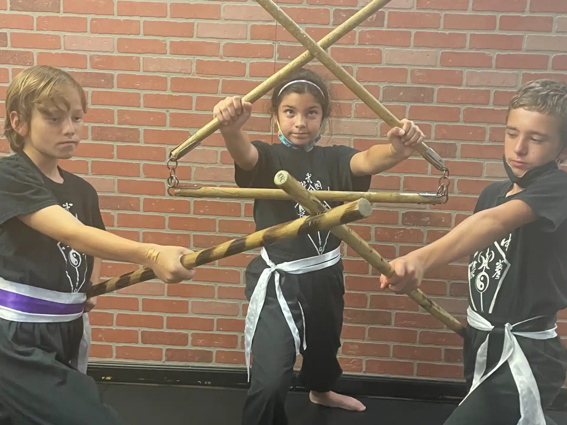 a group of boys holding swords