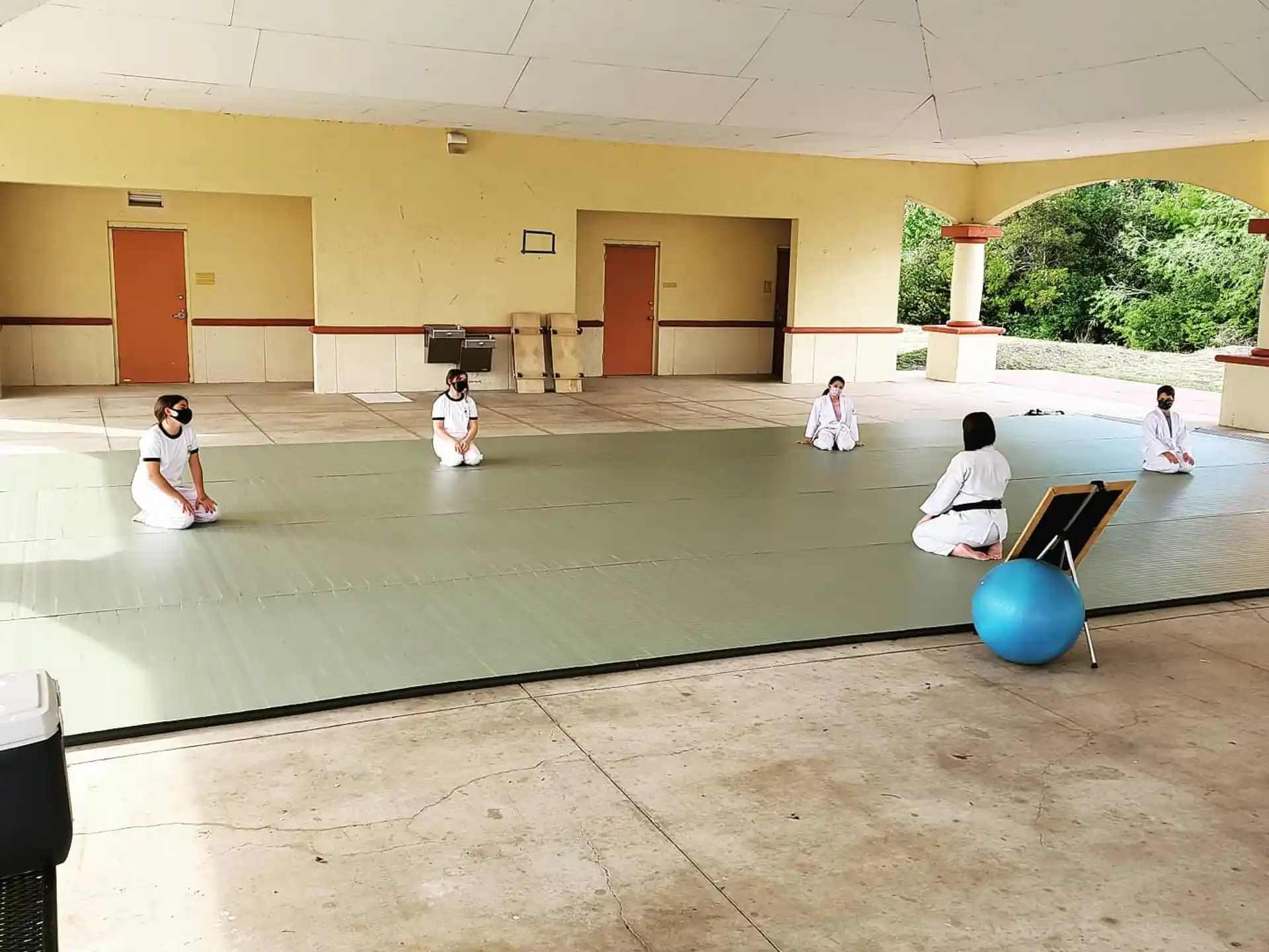 a group of kids playing with a ball in a courtyard