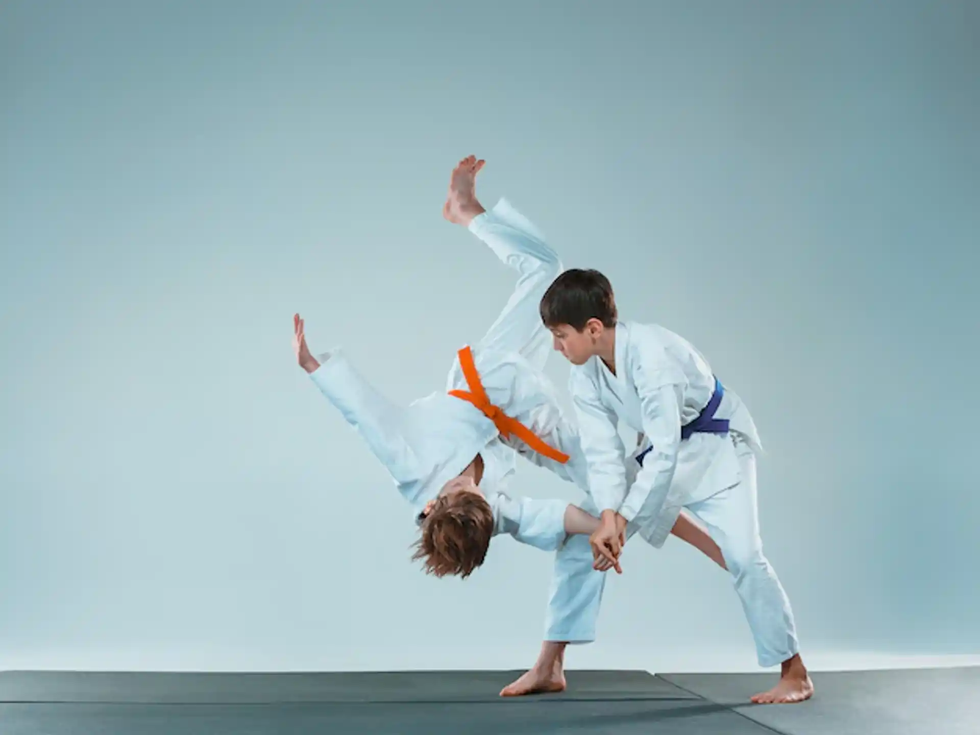 a man and a woman in karate uniforms
