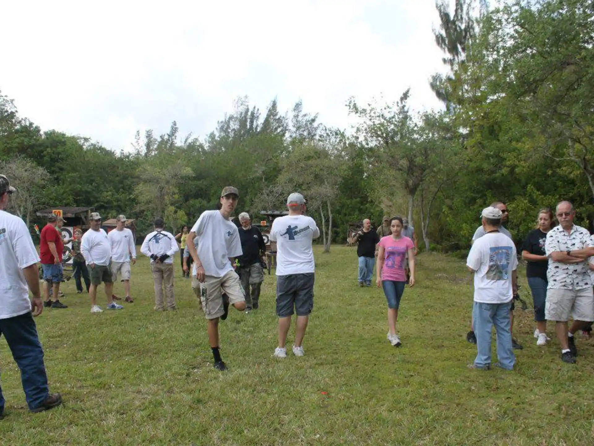 a group of people standing in a field