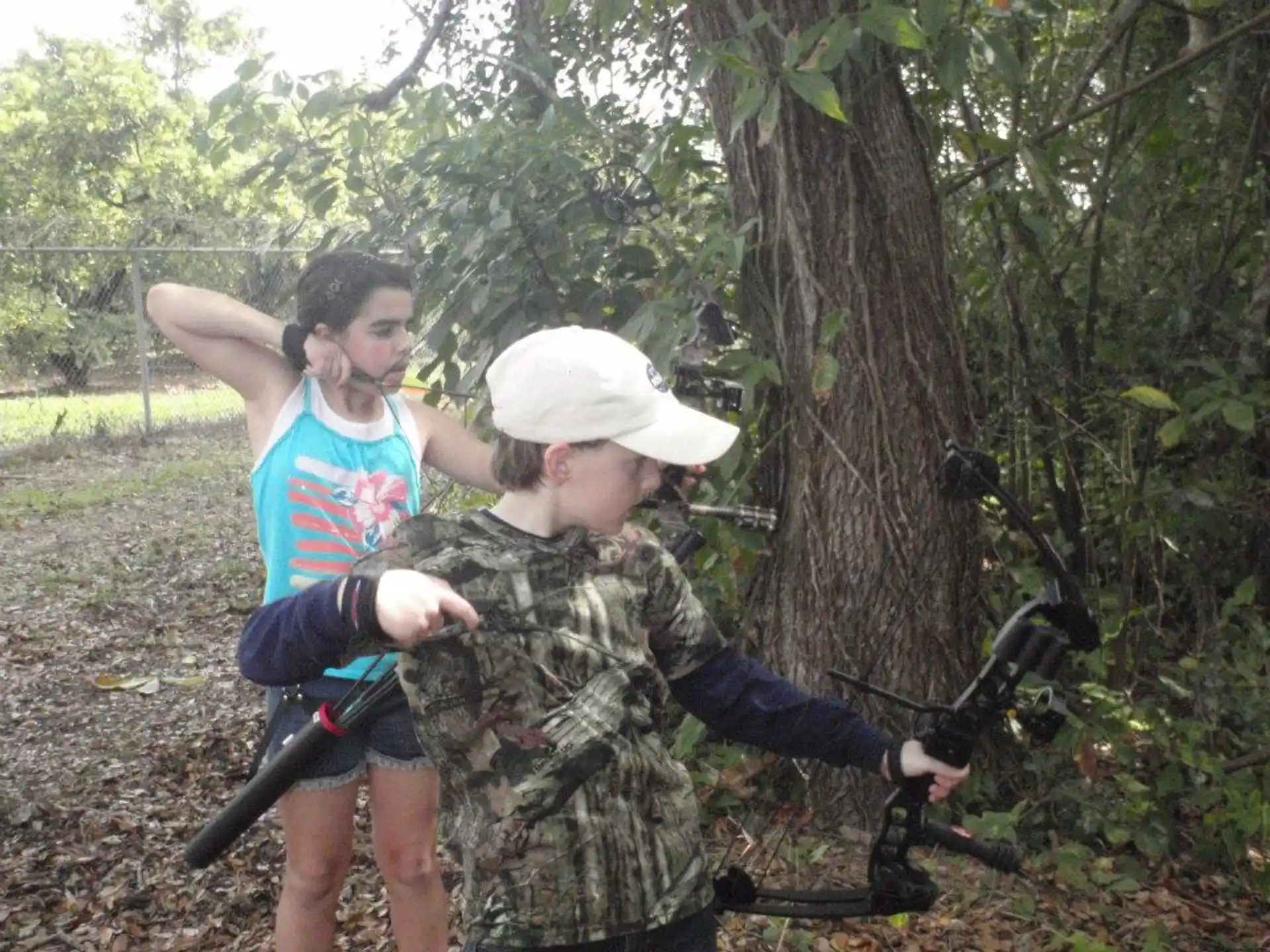 a man and a woman shooting a bow and arrow