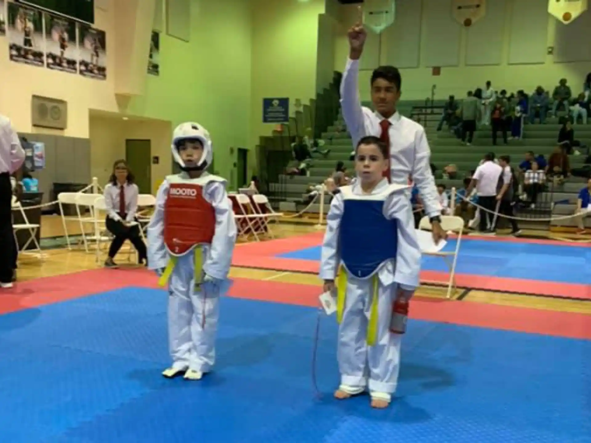 a couple of kids in karate uniforms