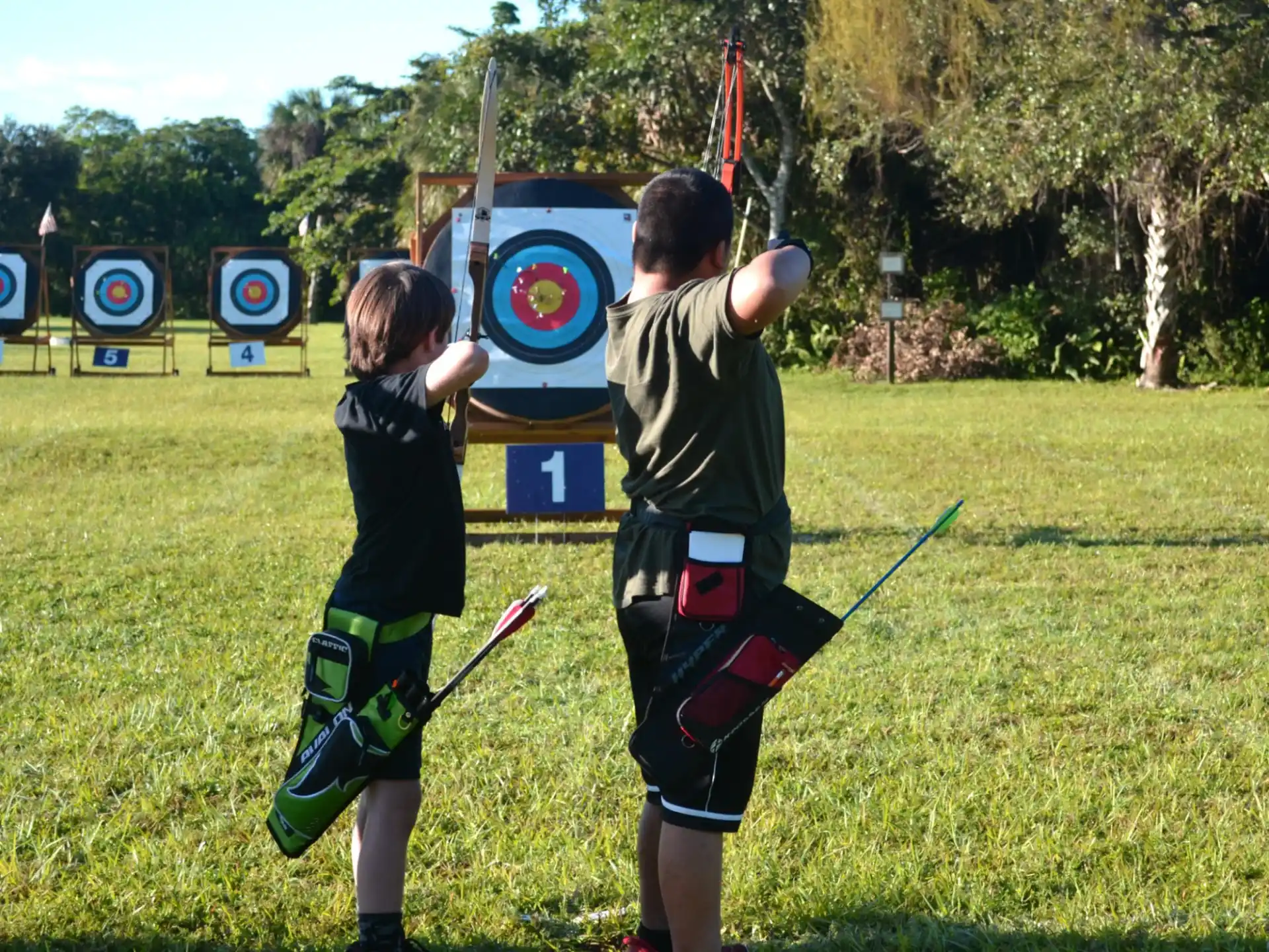 two boys playing with sticks