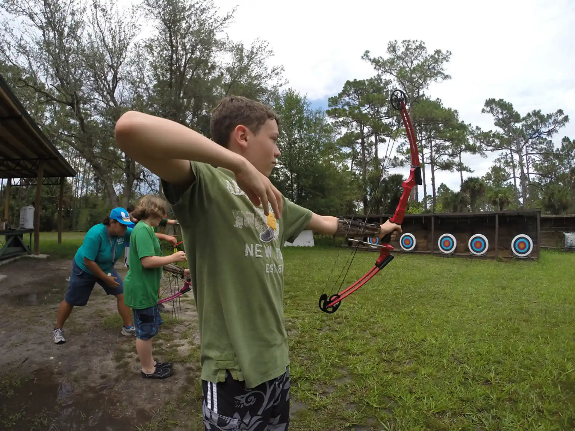 a group of people playing with bows and arrows