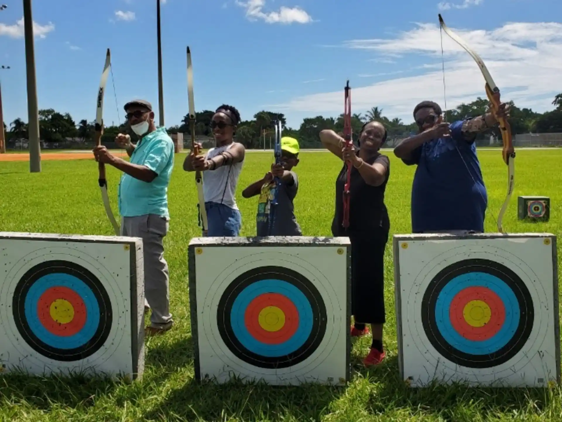 a group of people holding bows and arrows