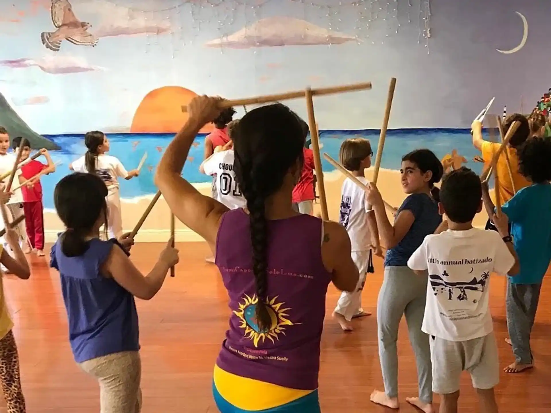 a group of children playing with sticks