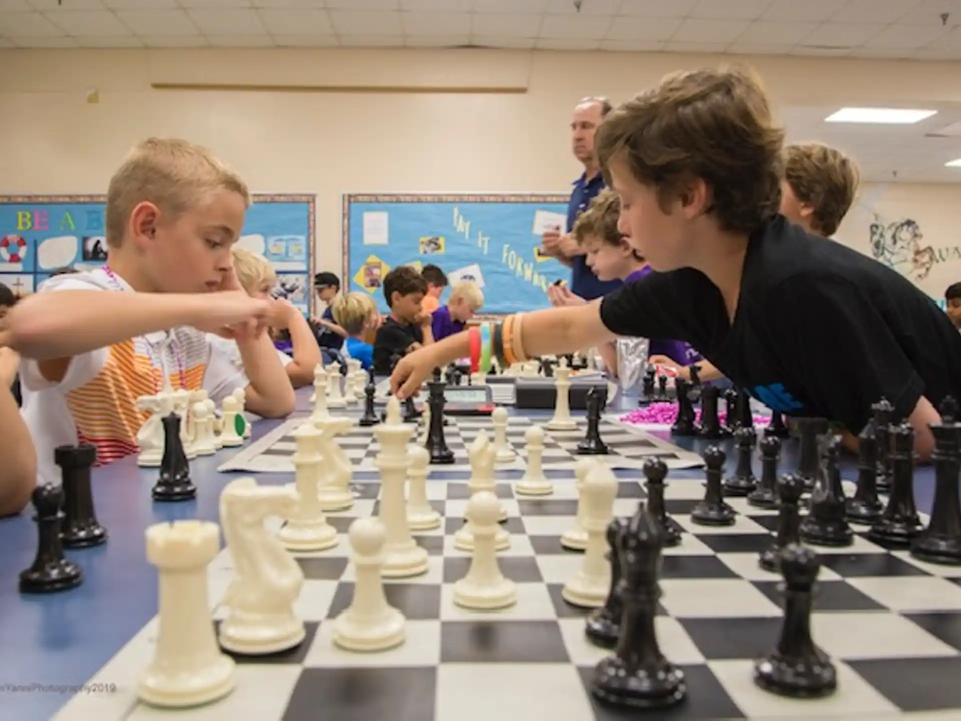 a group of people playing chess