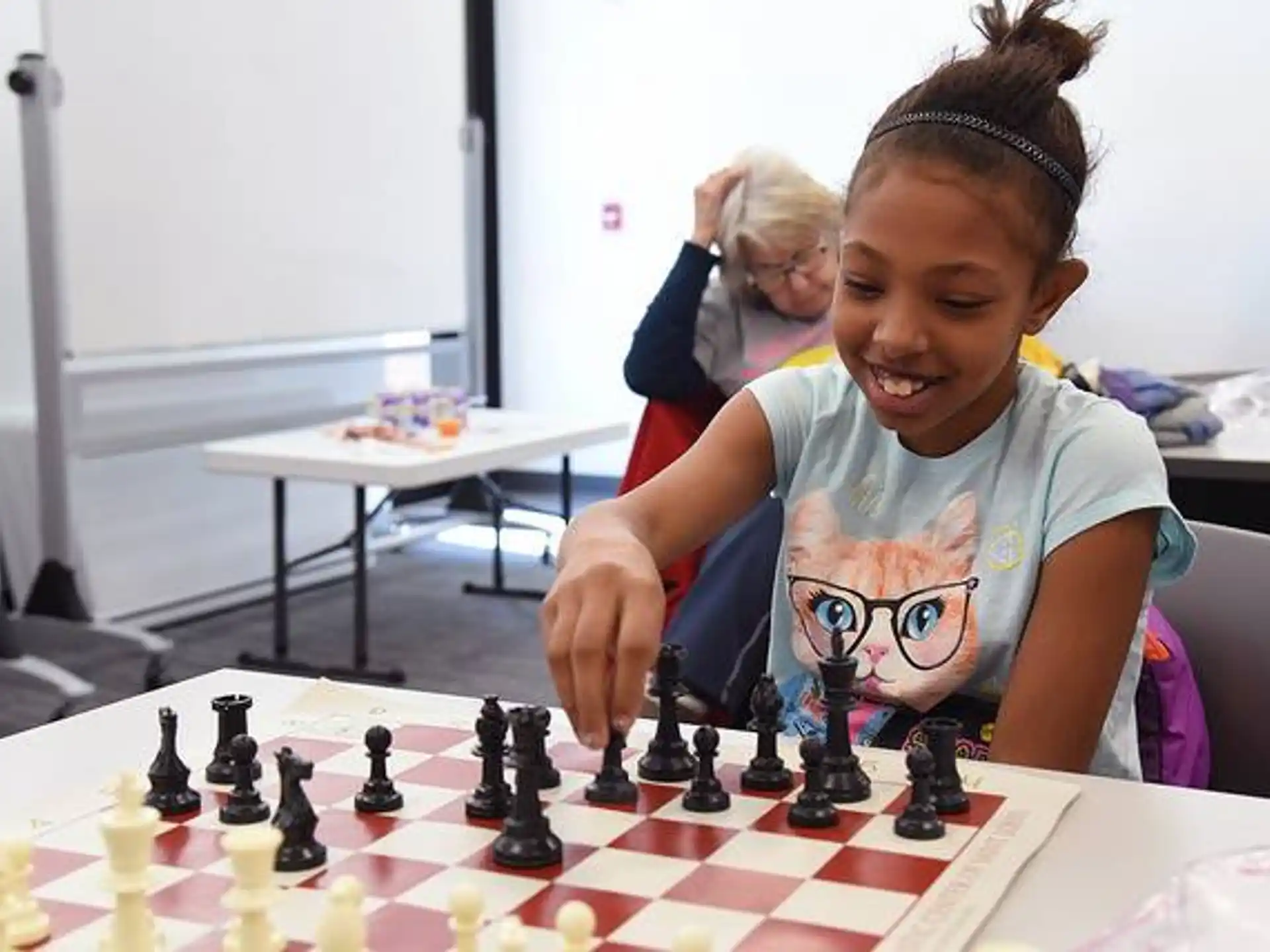 a young girl playing chess
