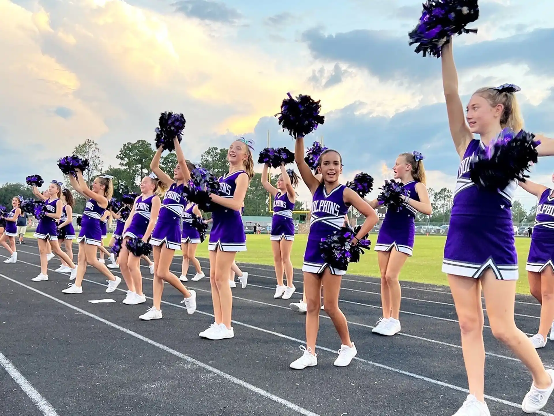 a group of cheerleaders on a track