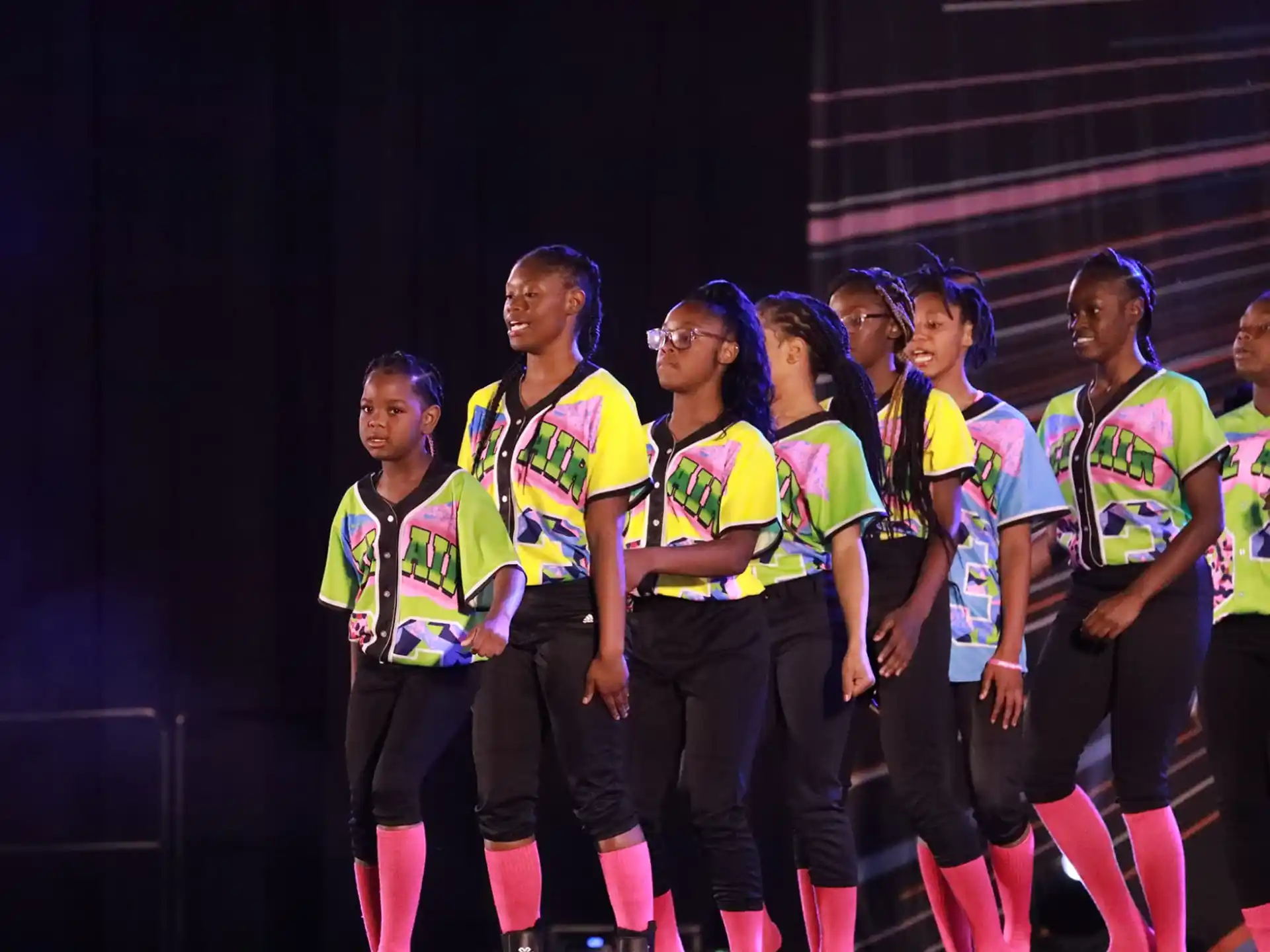 a group of girls in matching outfits