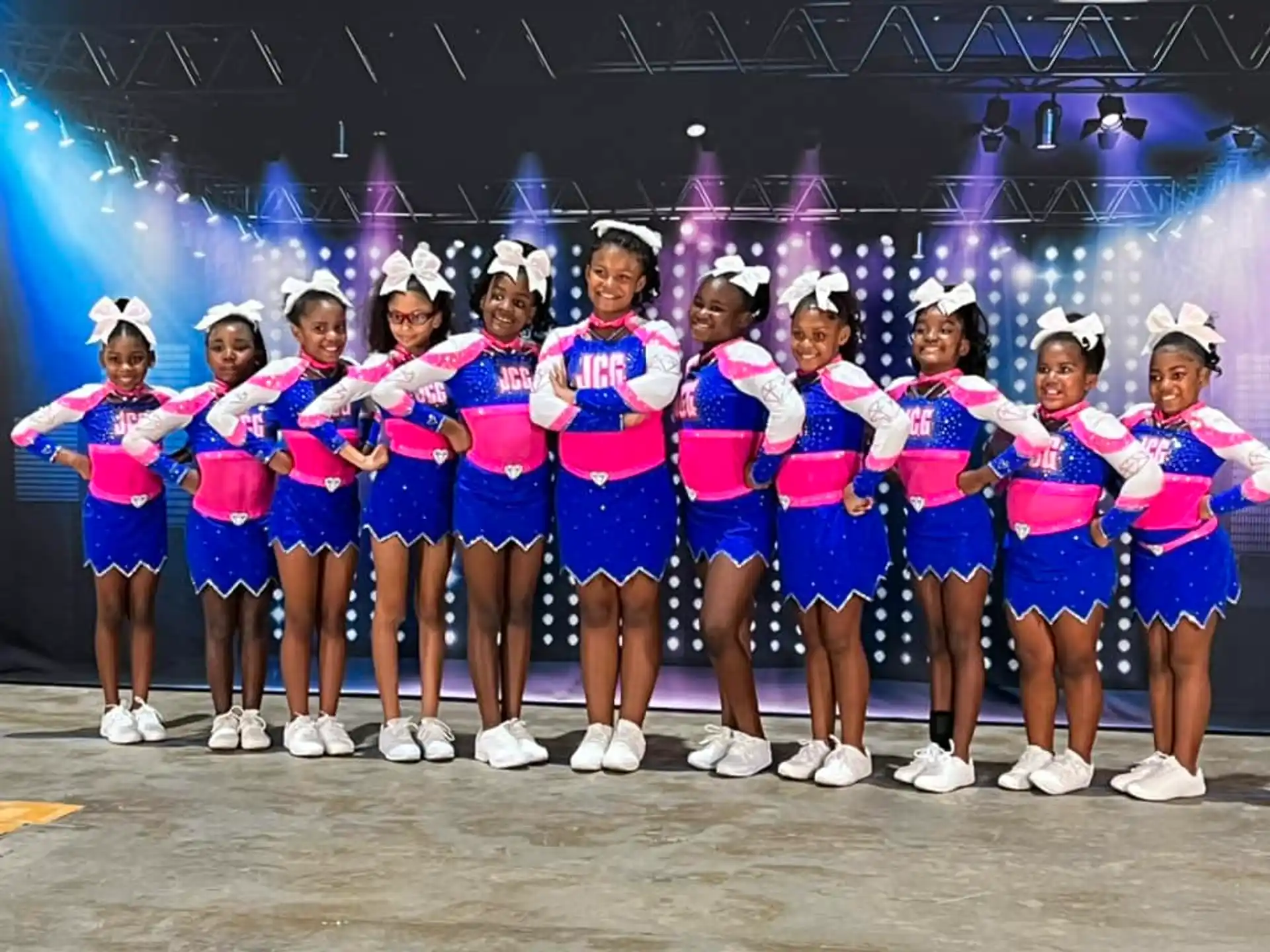 a group of girls in matching outfits