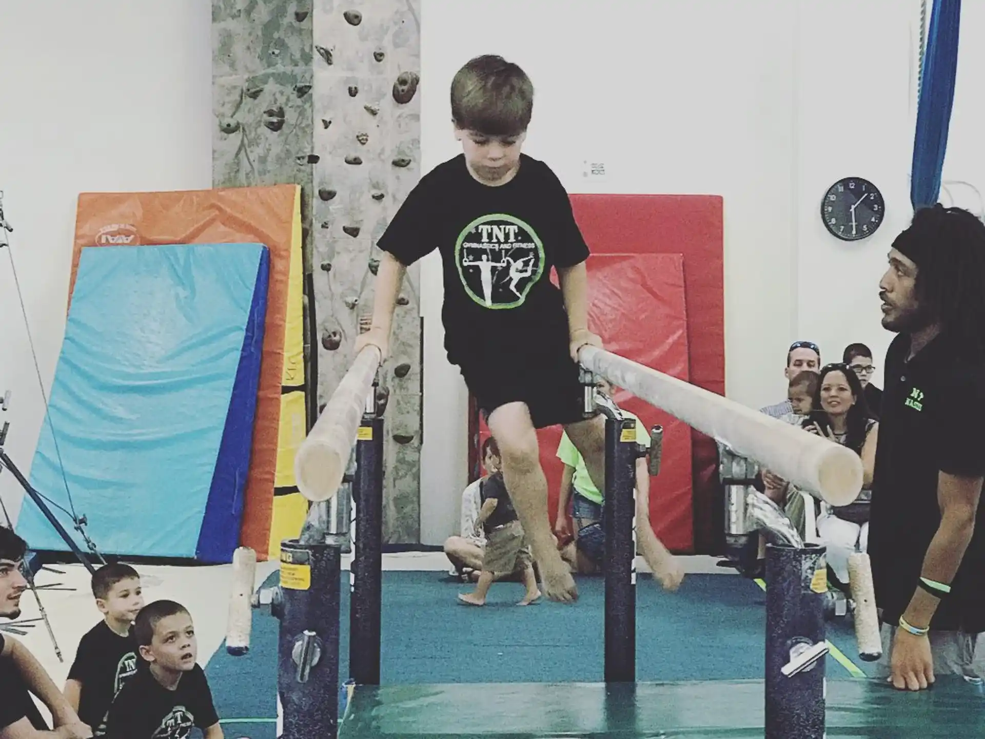 a boy jumping on a pole