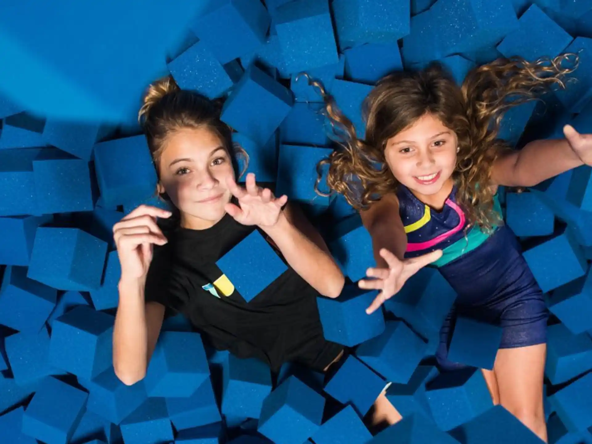 a couple of girls in a blue tunnel