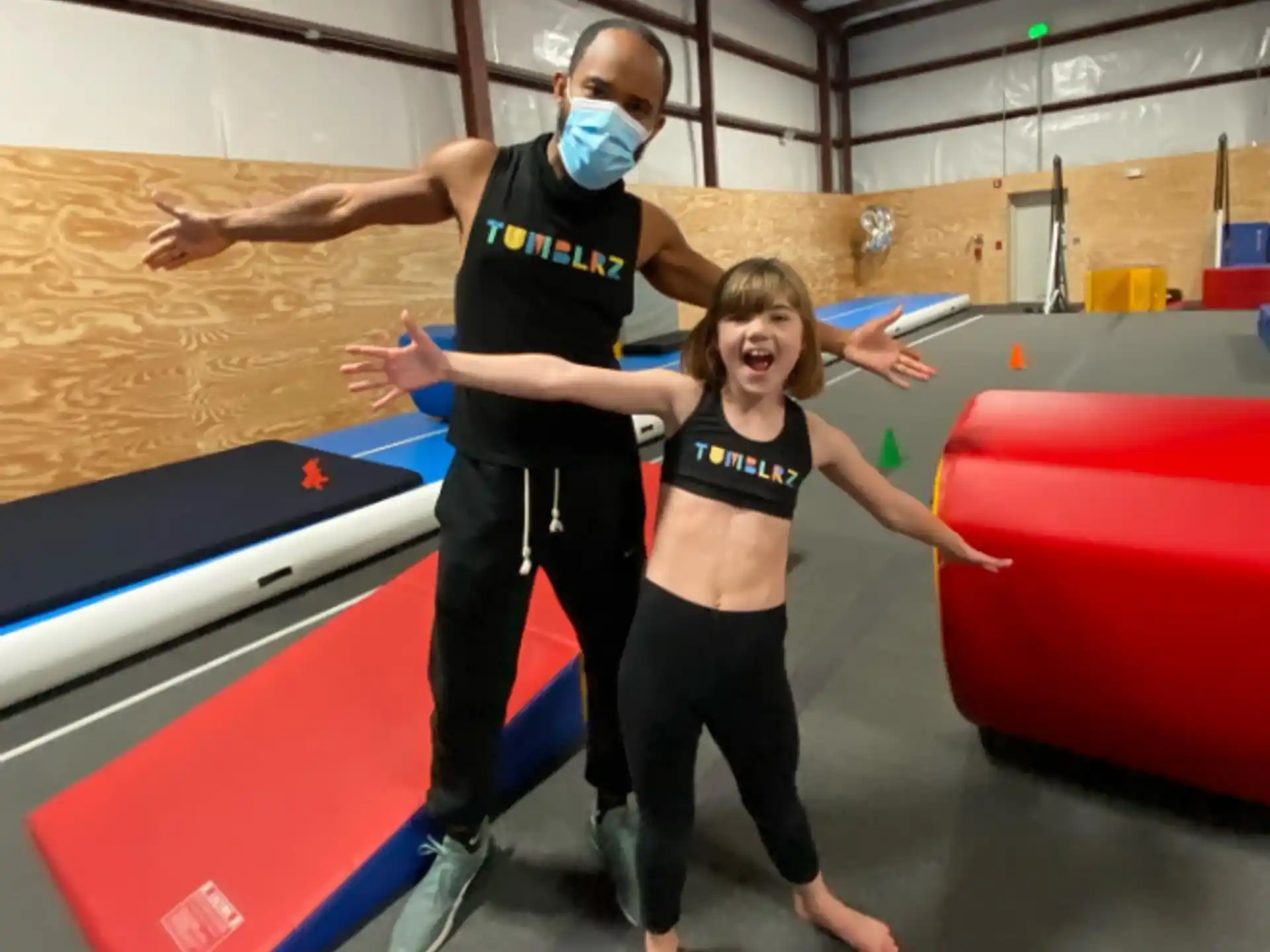 a man and woman wearing masks
