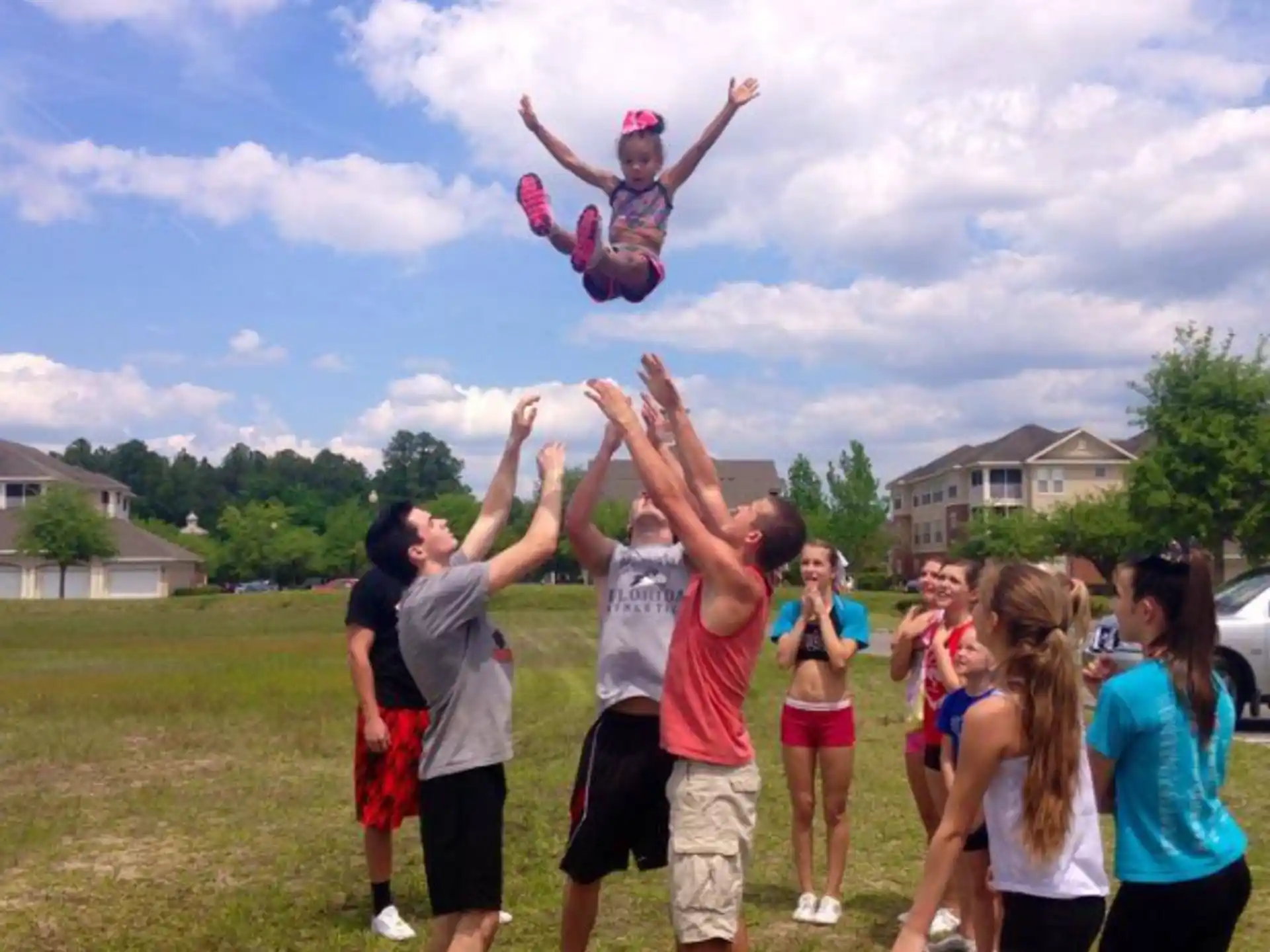 a group of people holding a child on their shoulders
