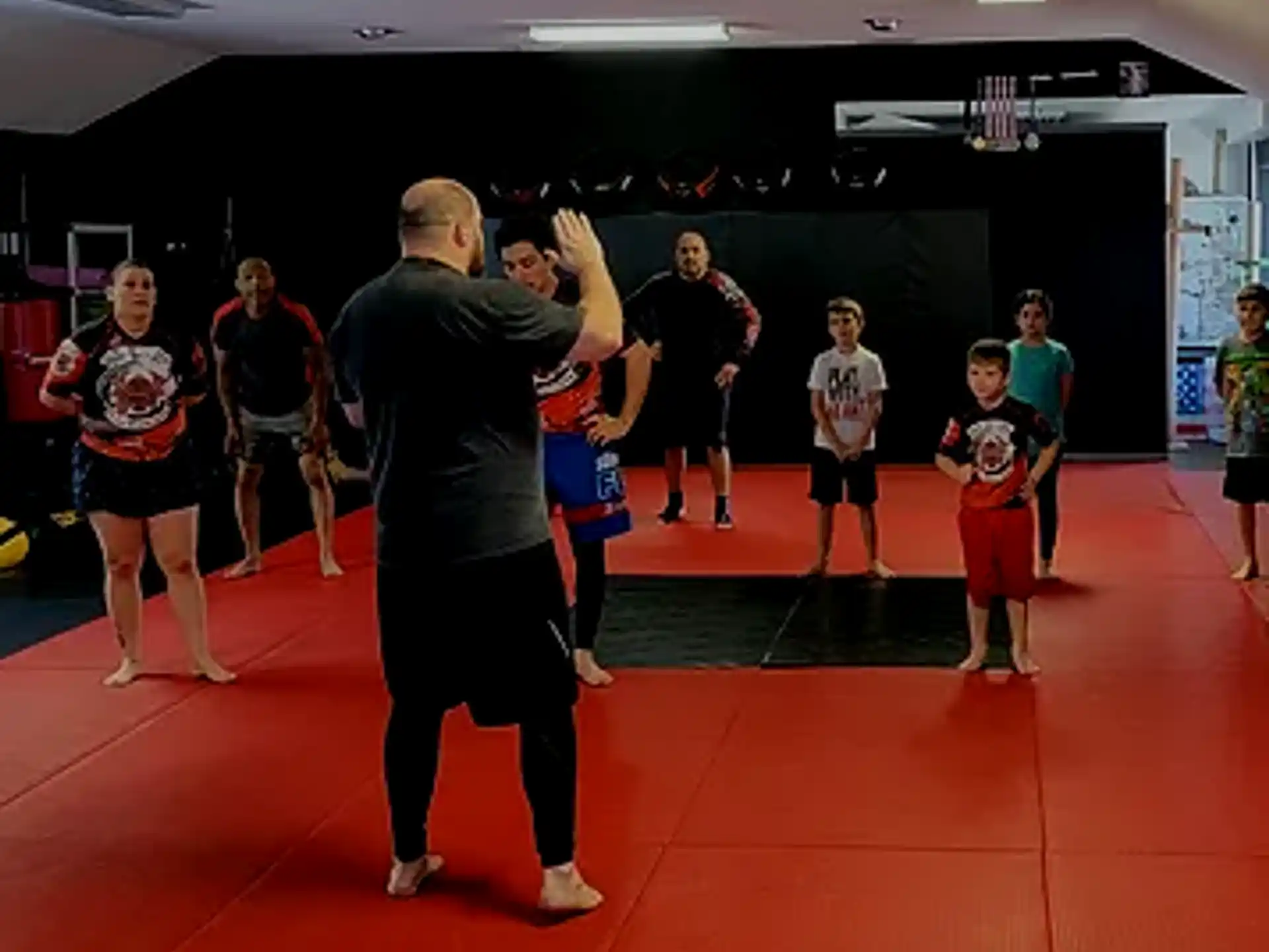 a person standing in front of a group of people in a gym
