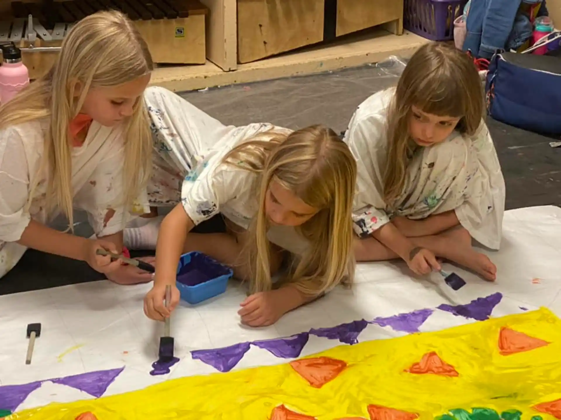 a few young girls painting