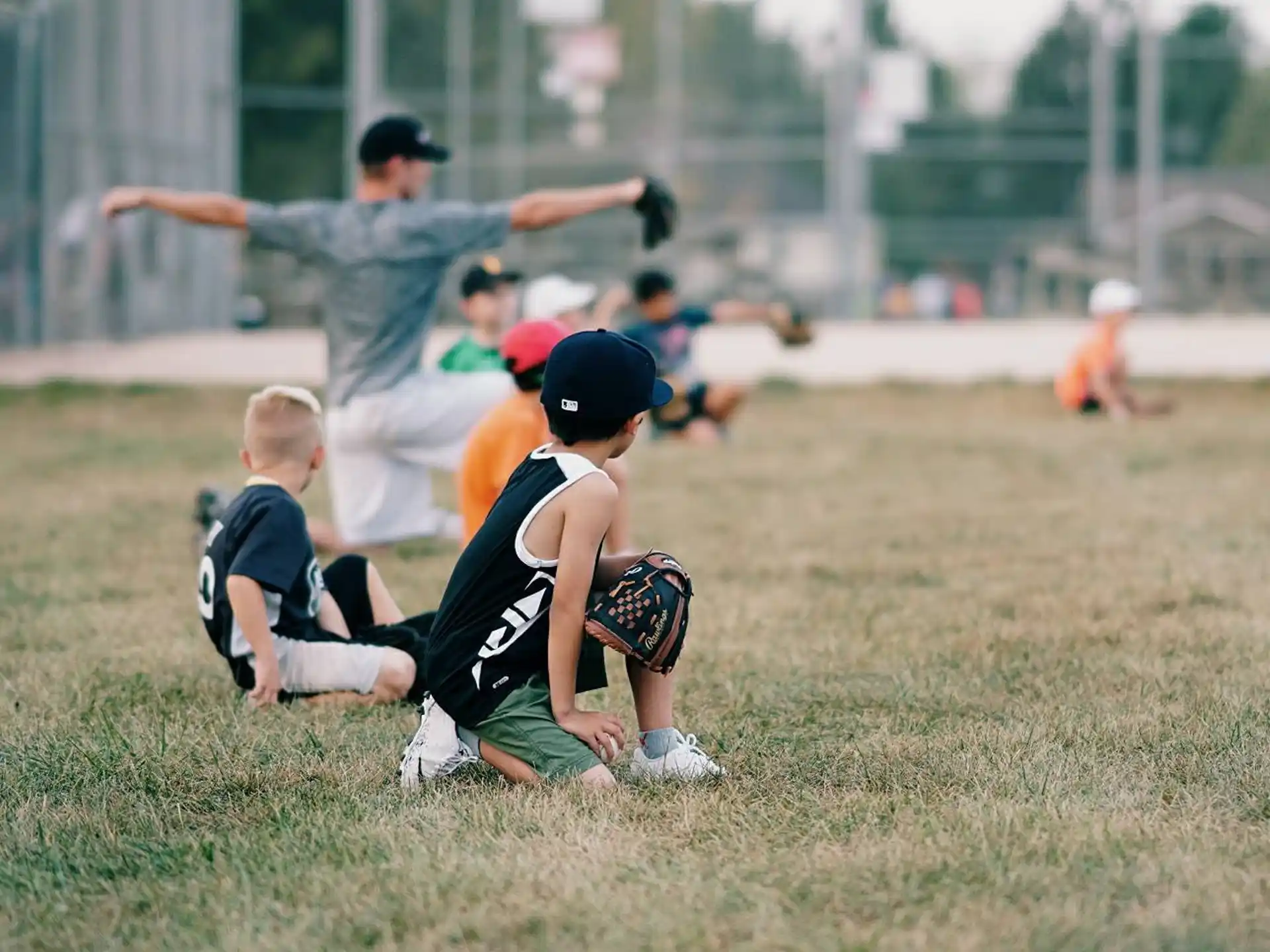 a group of kids playing baseball
