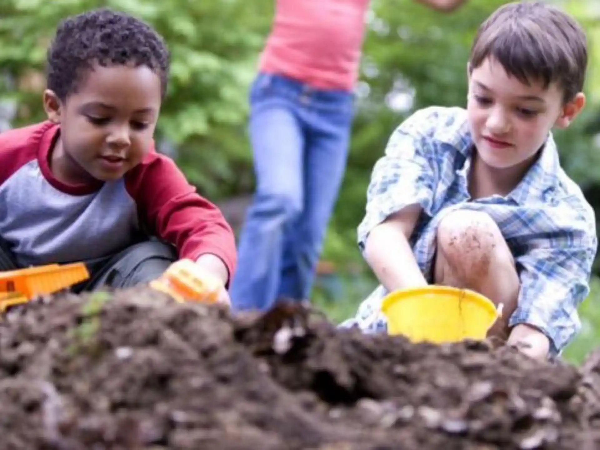 a few children digging in the dirt
