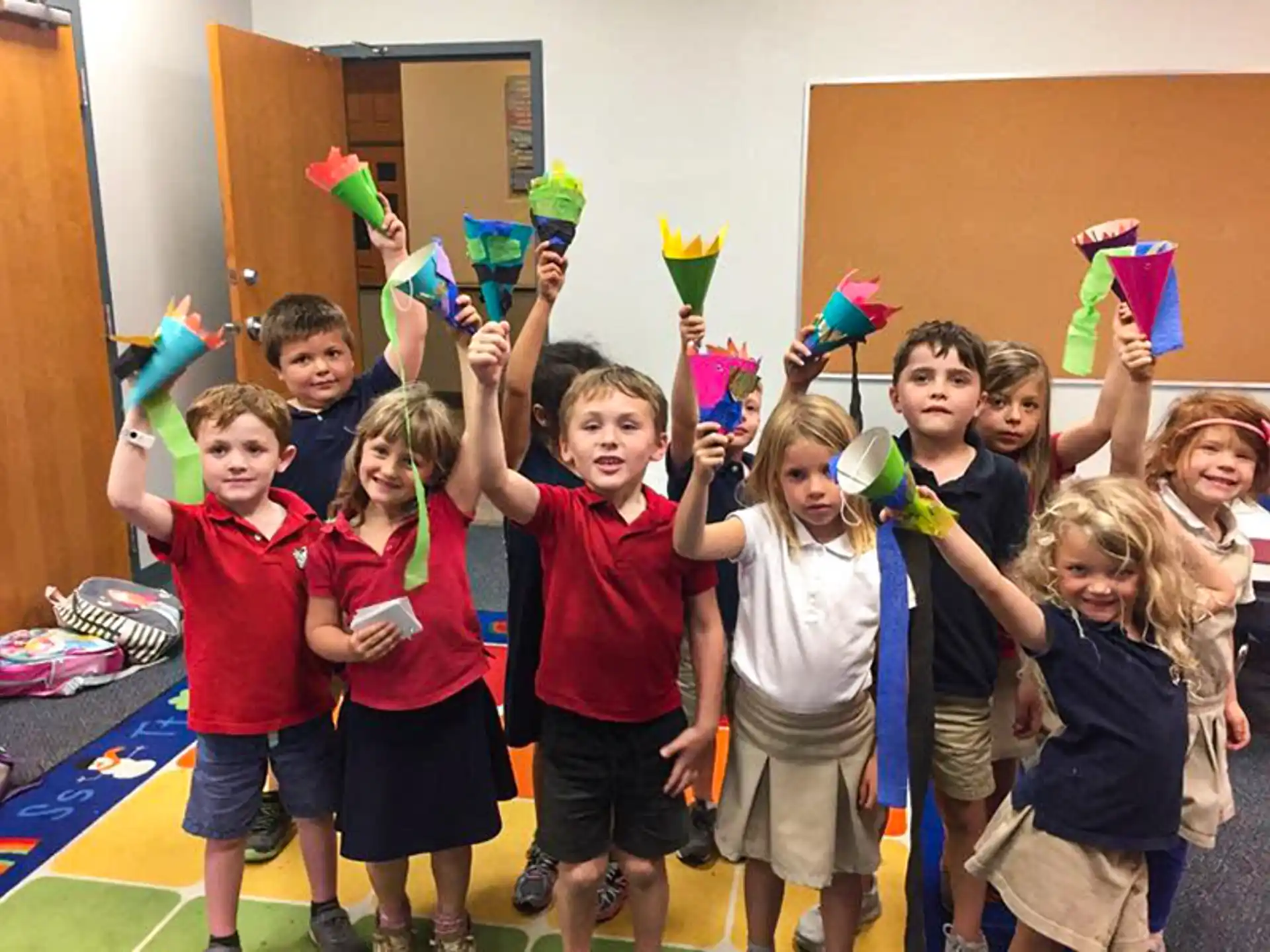 a group of children holding colorful objects