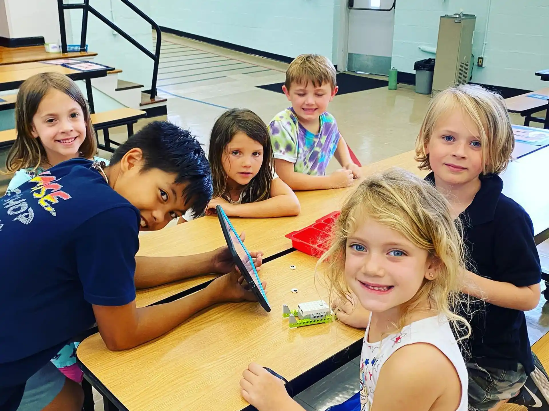 a group of children sitting around a table