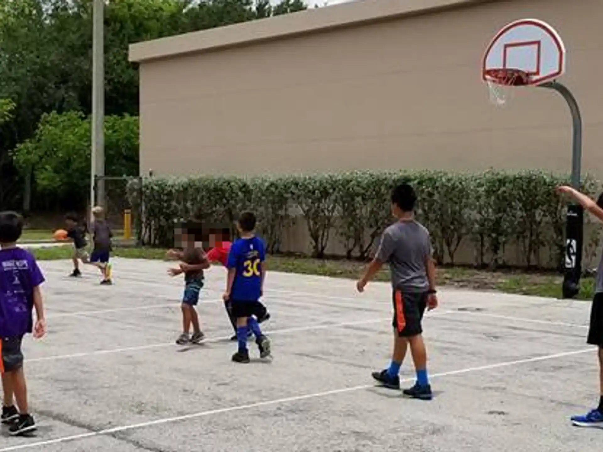 a group of people playing basketball