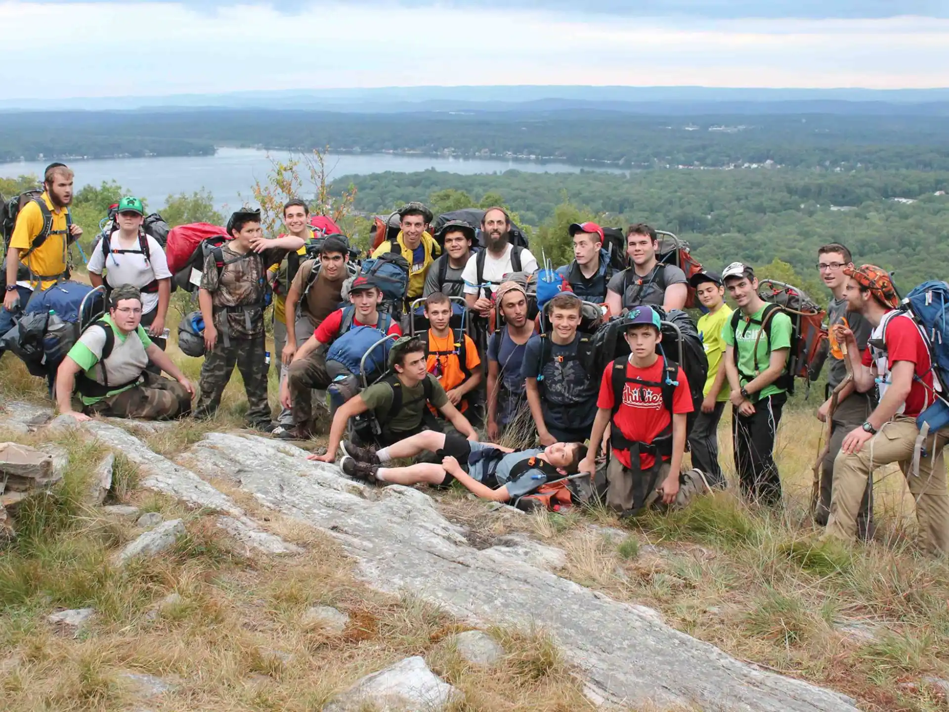 a group of people posing for a photo on a mountain