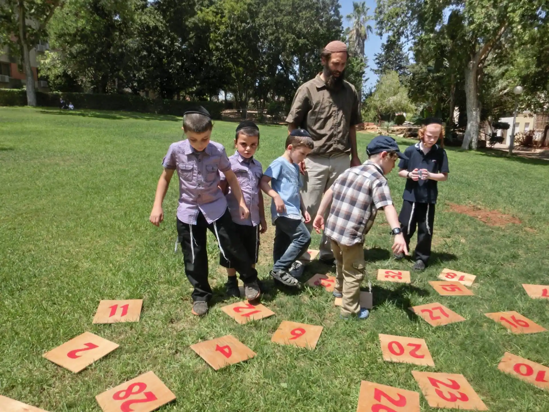 a group of people standing on a grass field with signs