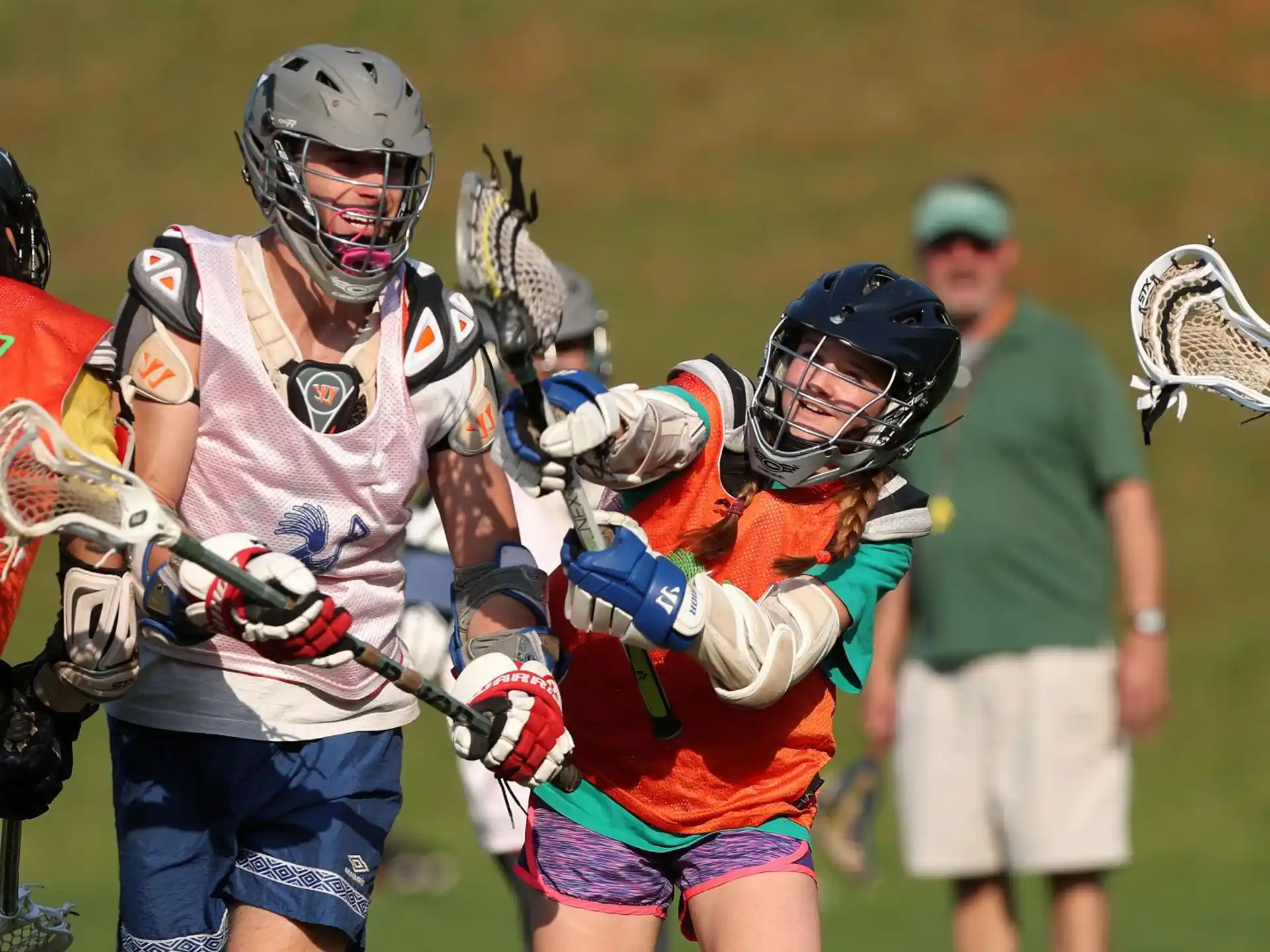a group of people playing lacrosse