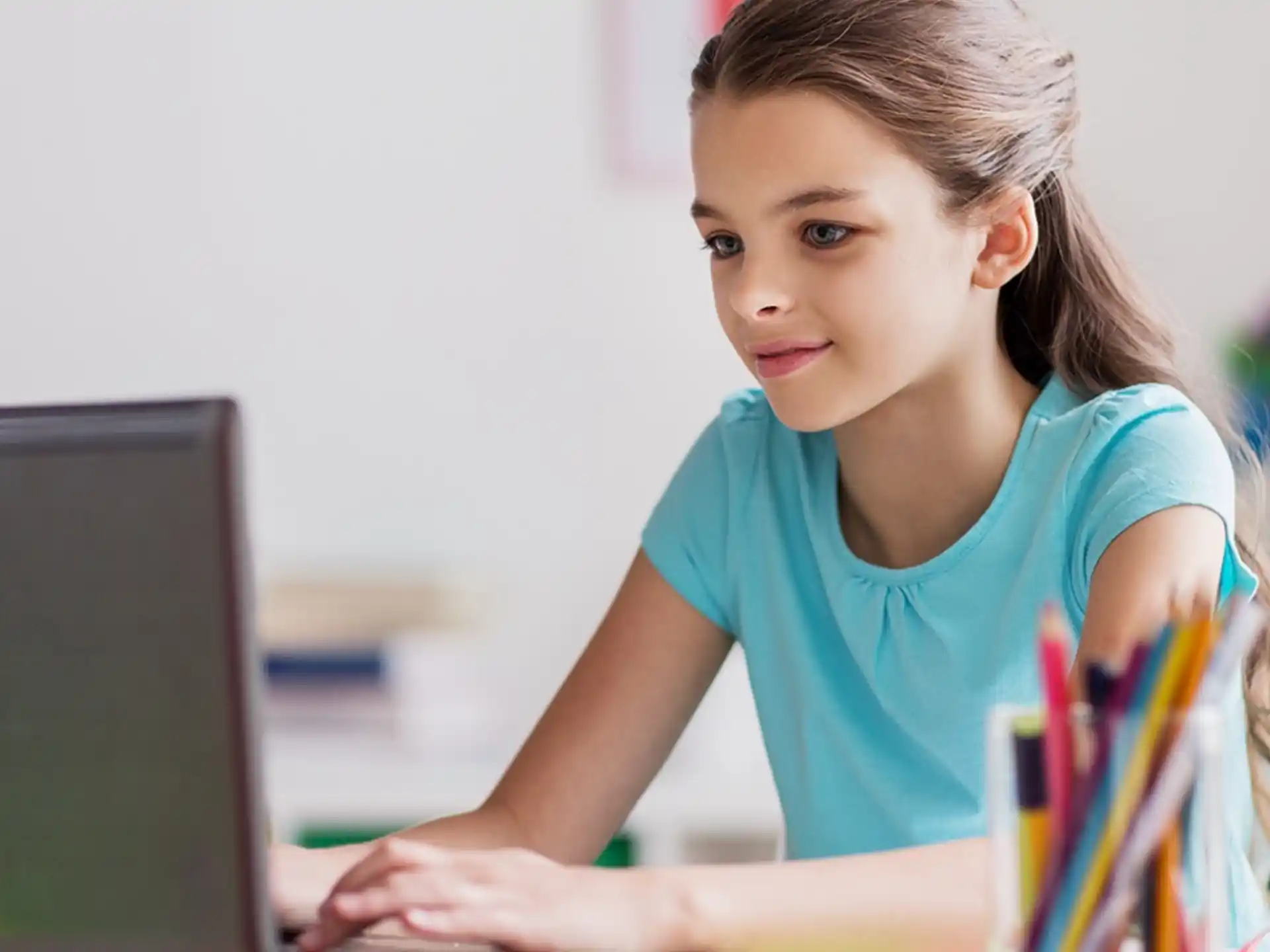 a young girl using a laptop