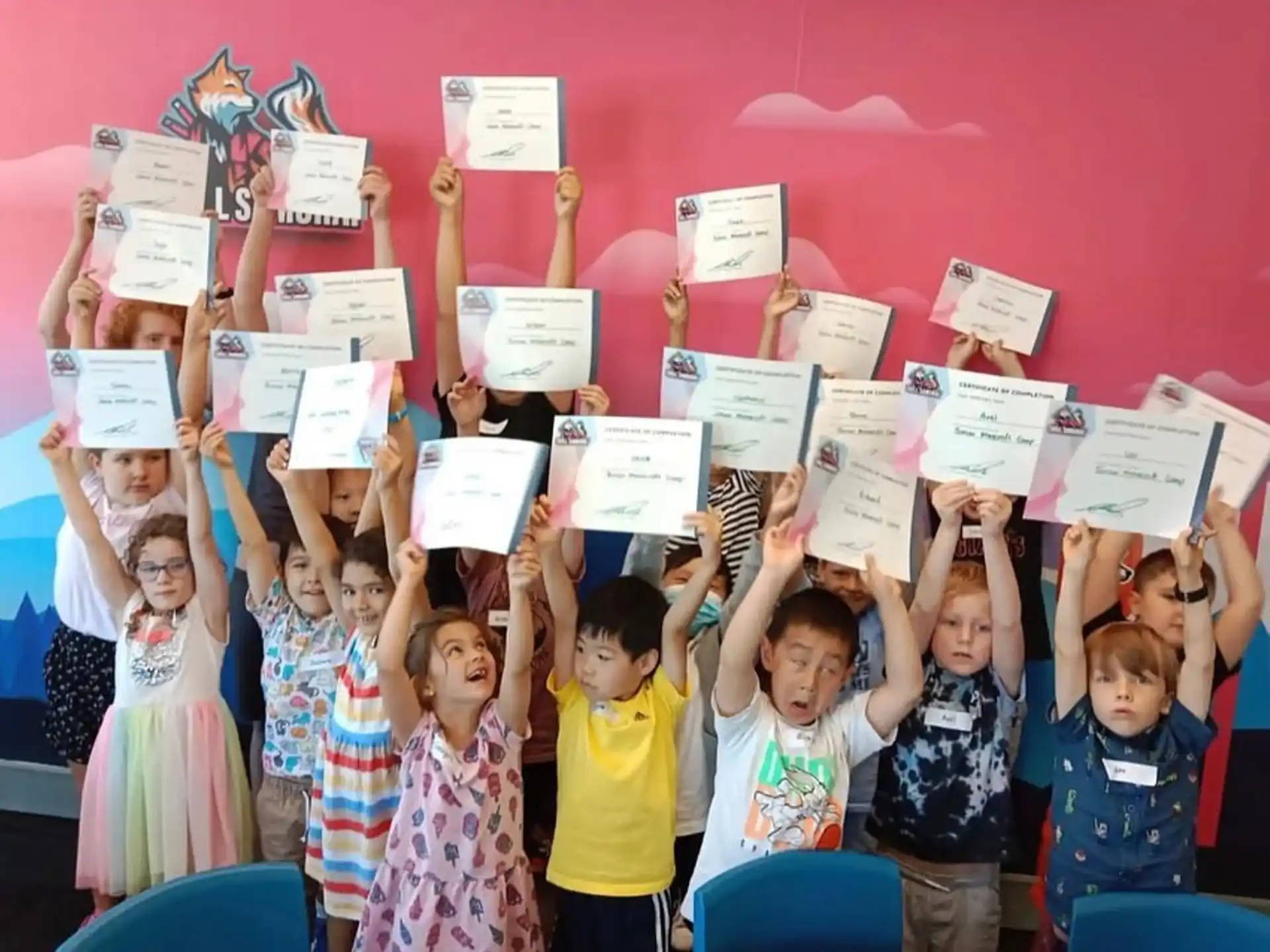 a group of children holding up paper signs