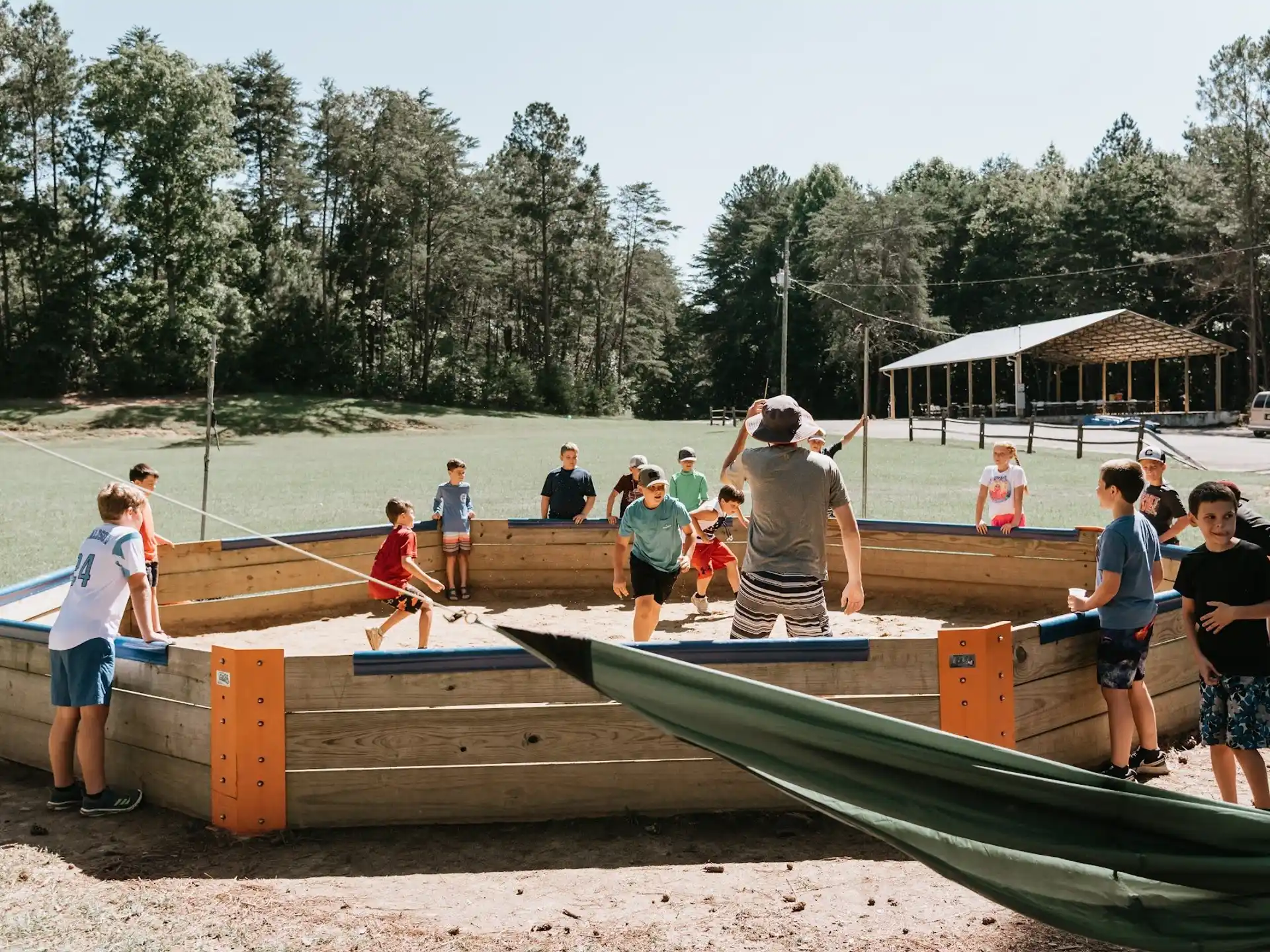 a group of people playing on a wooden platform in a pond