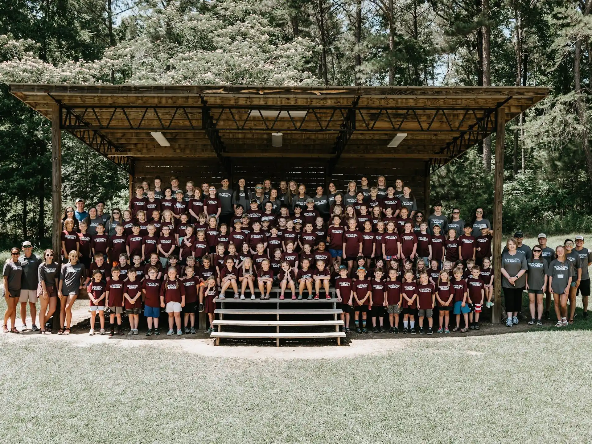 a group of people posing for a photo in front of a gazebo