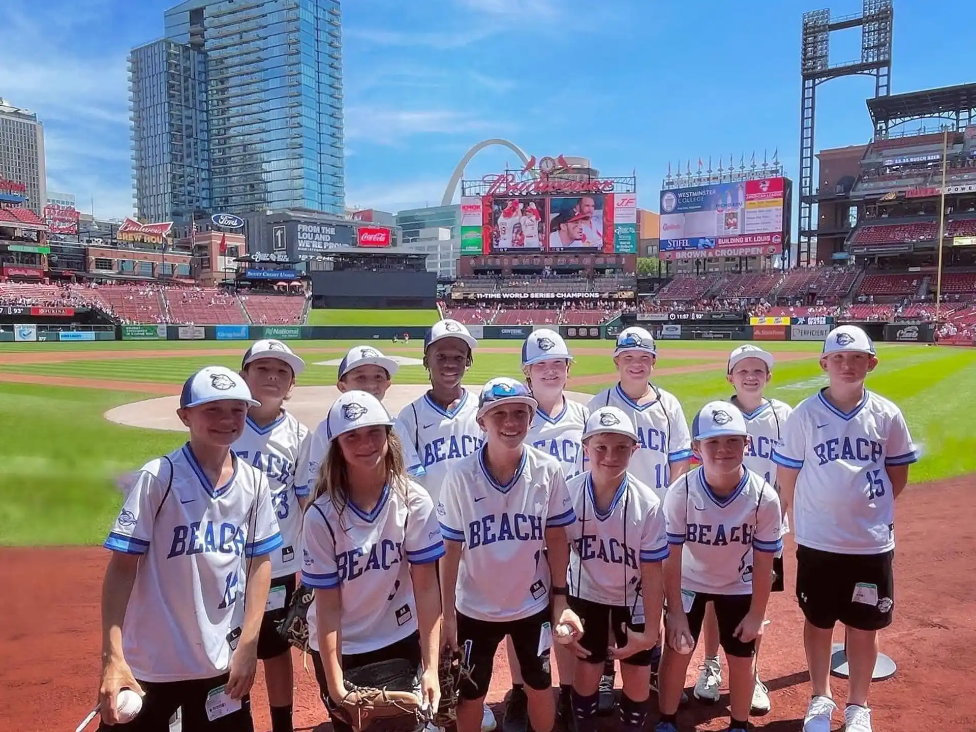 a group of people posing for a photo in front of a stadium
